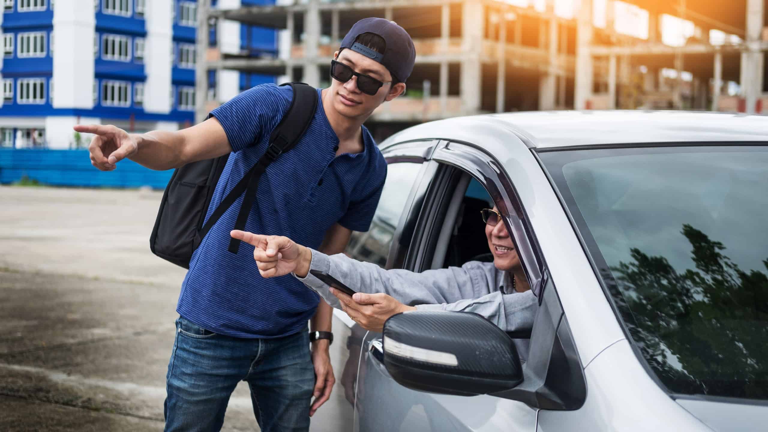 tourists or traveler seek advice map with smart phone from taxi drivers