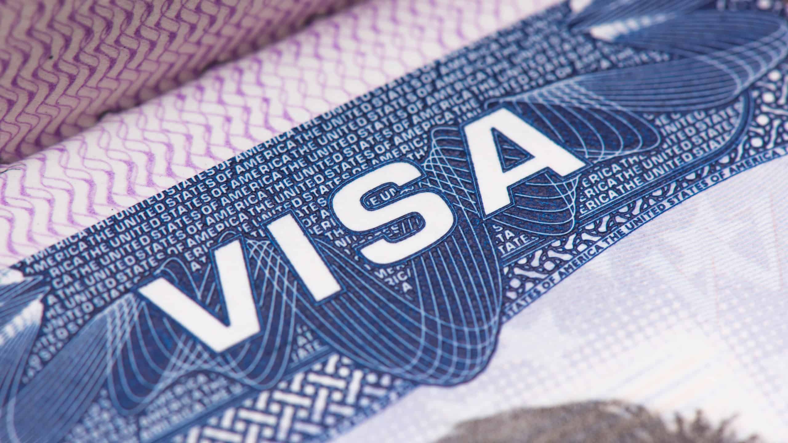 Close up of text VISA on USA visa stamp in passport.