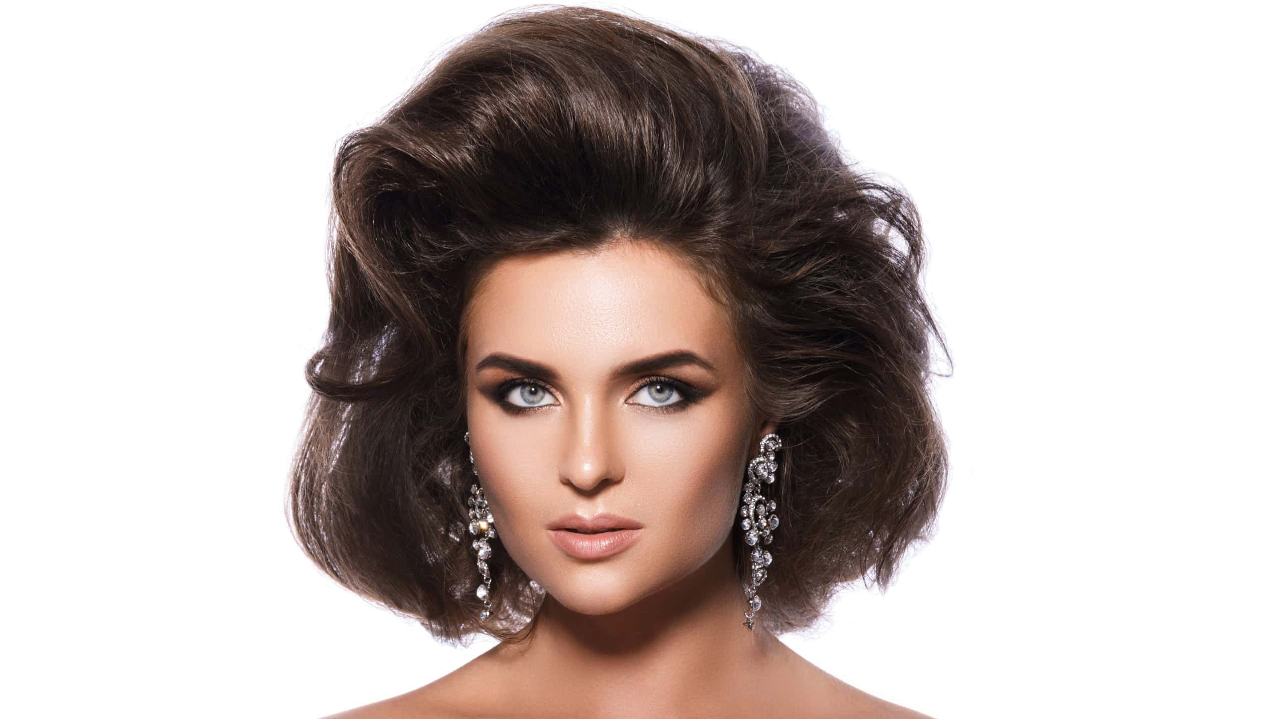 Portrait of gorgeous woman with a beautiful hairstyle and make-up on white background