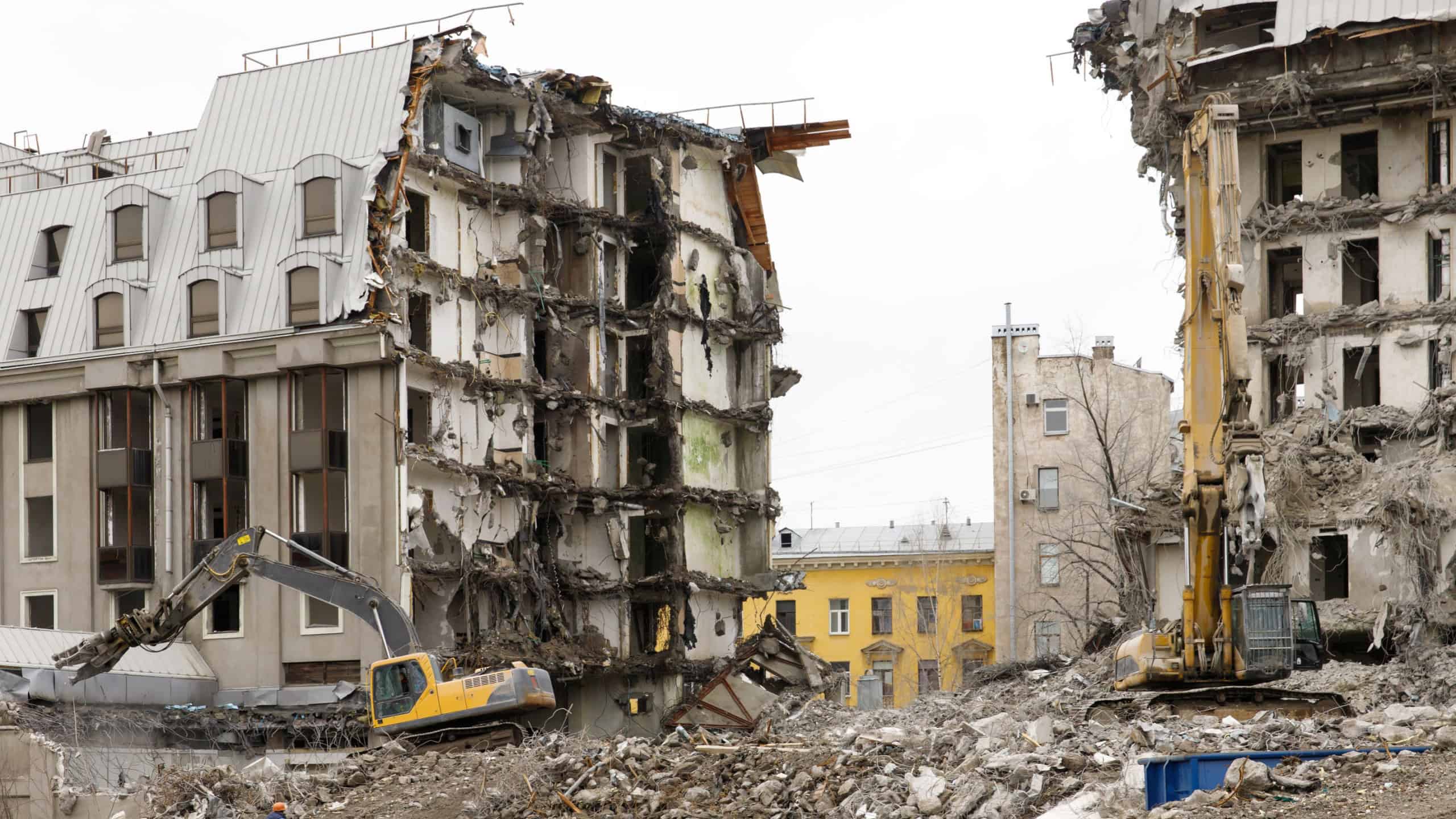 Demolition of concrete apartment building with hydraulic excavator.Making place for new building in St.Petersburg Russia. 