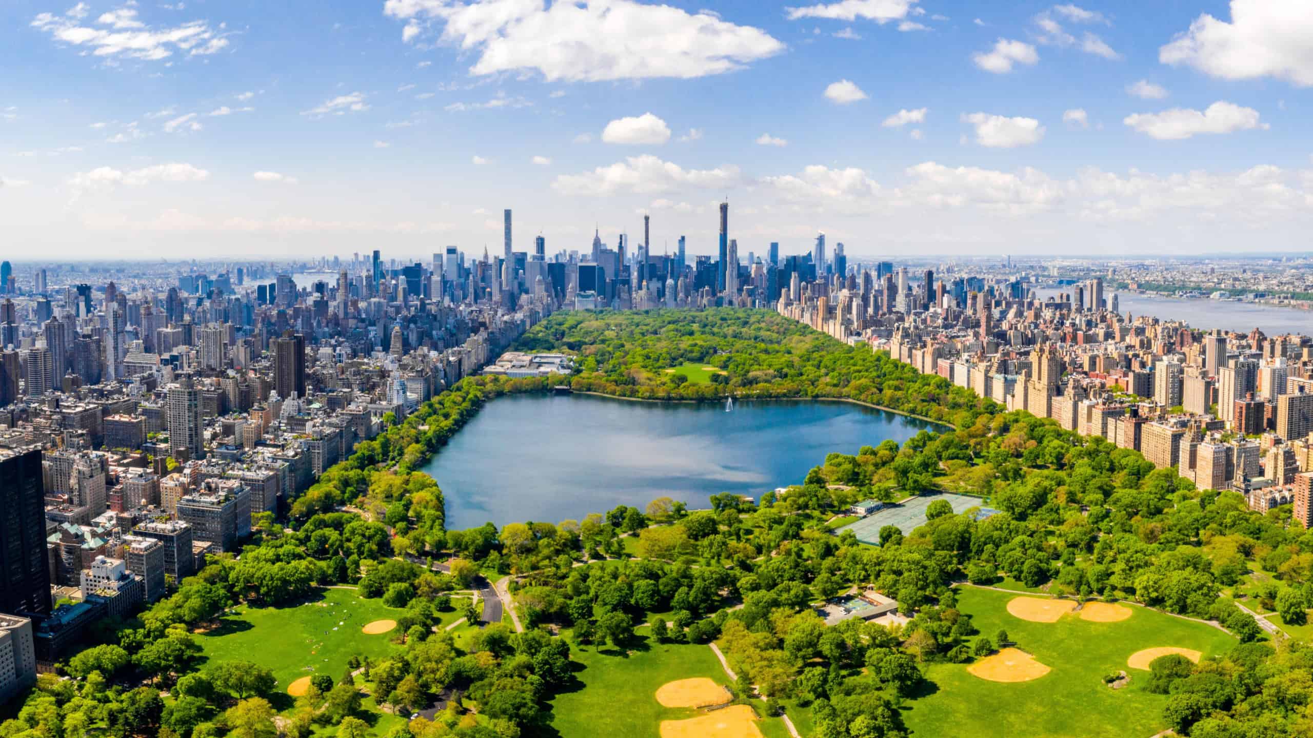 Central Park aerial view, Manhattan, New York. Park is surrounded by skyscraper. Beautiful view of the Jacqueline Kennedy Onassis Reservoir in the center of the park.