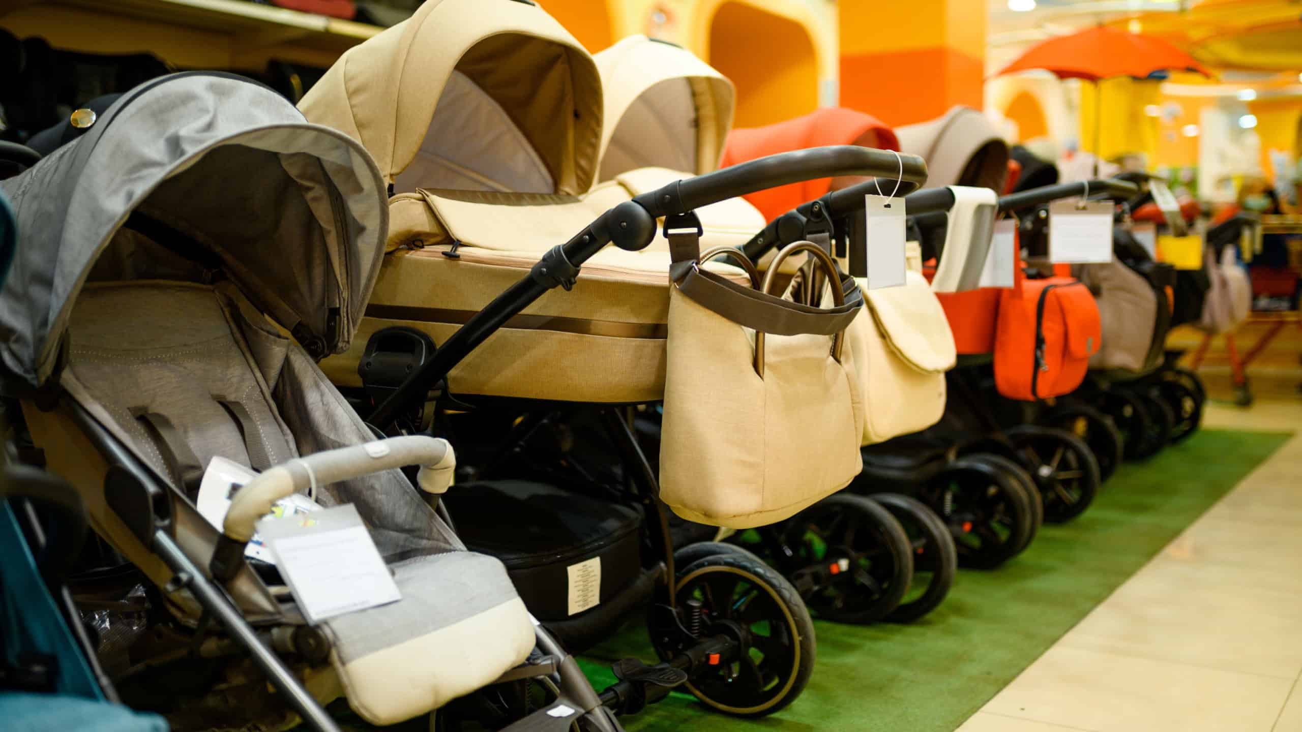 Row of baby strollers in children's store, nobody