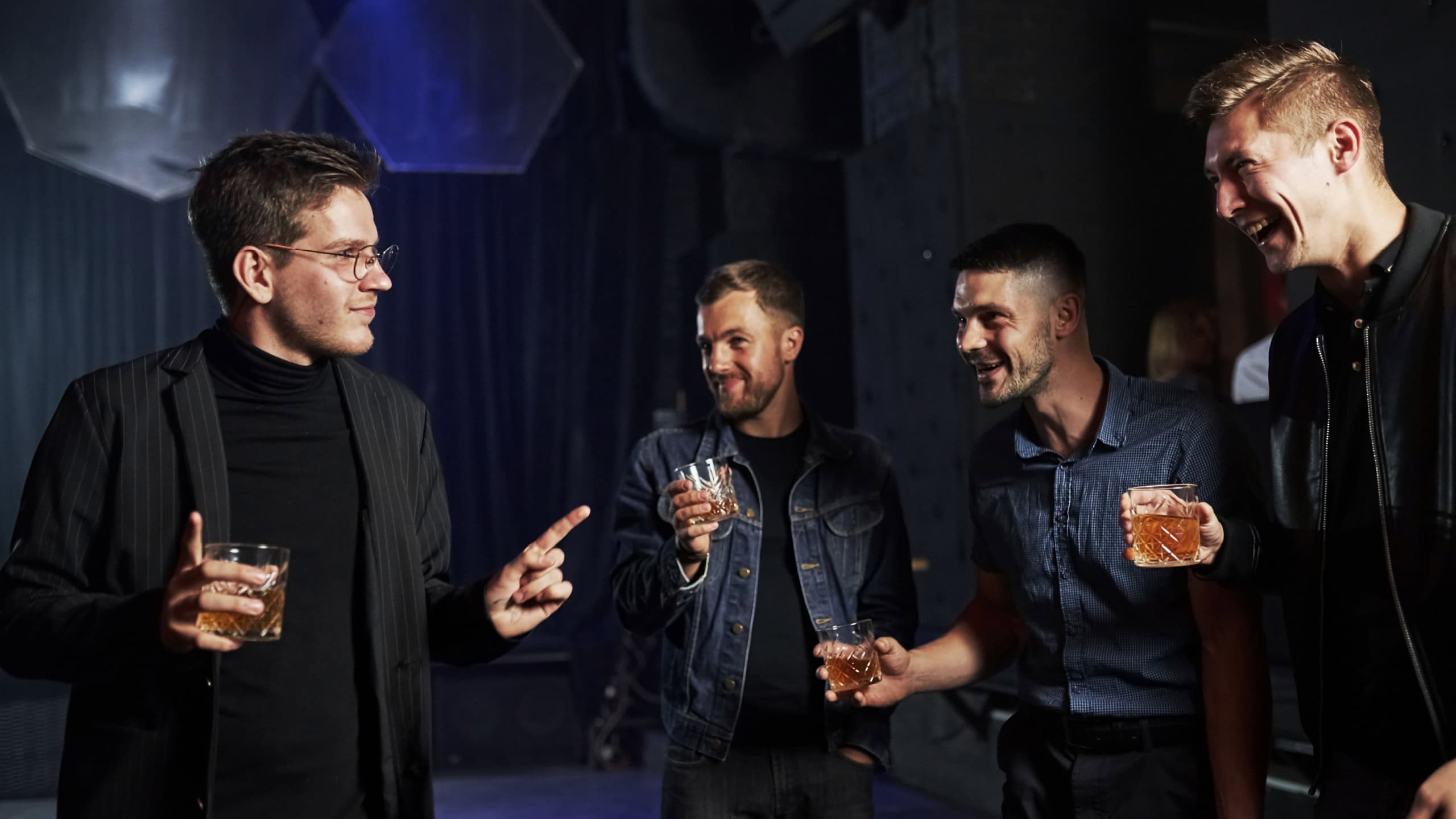 People have fun in the night club. With alcohol in hands.