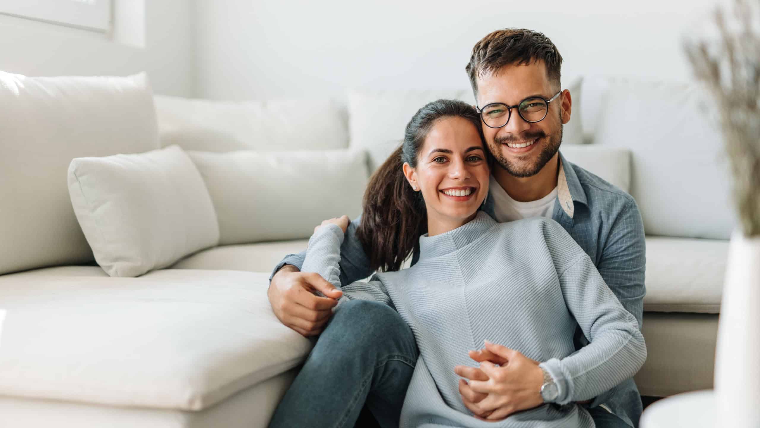 Beautiful couple, holding hands, posing for camera.