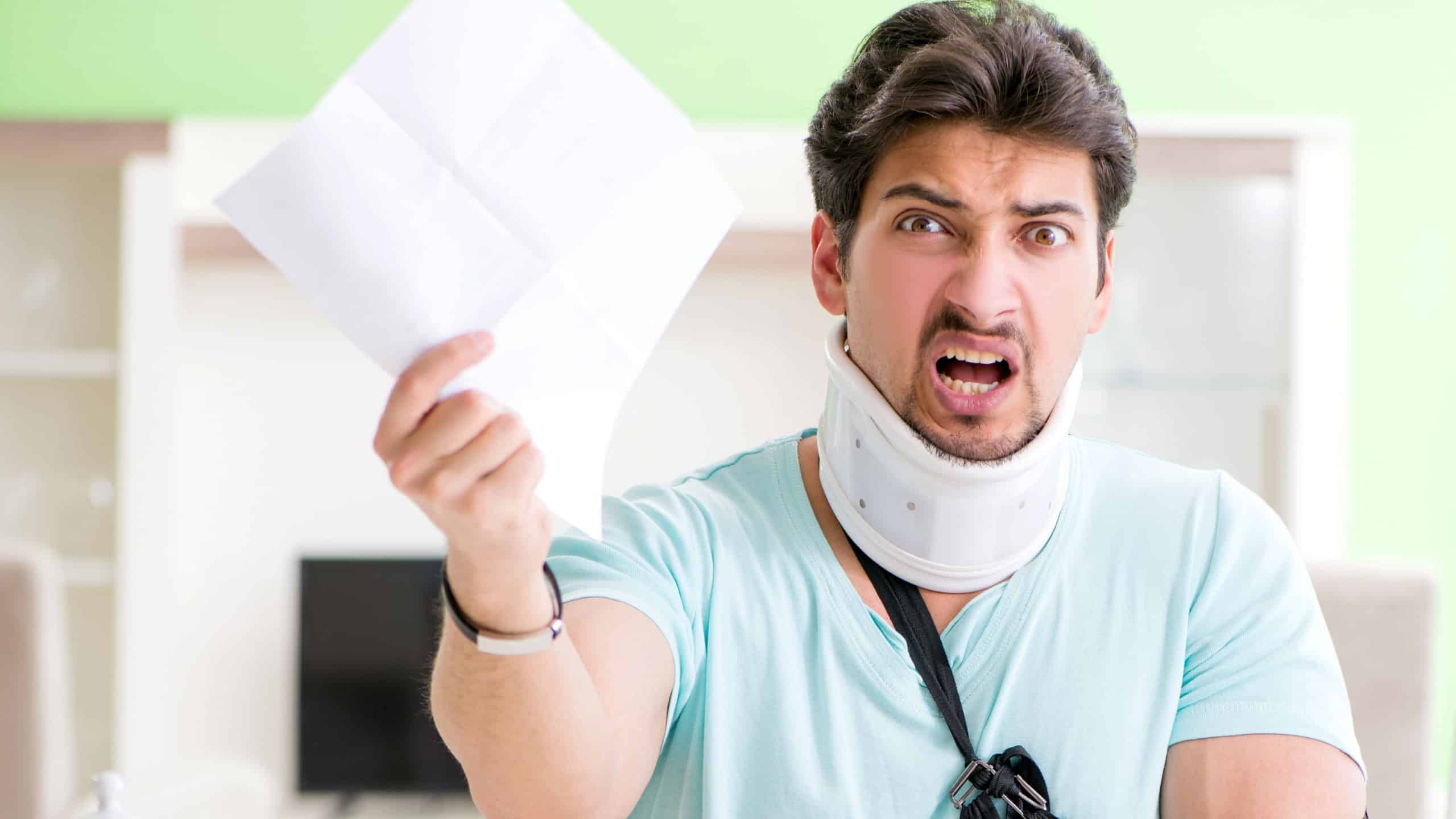 Young student man with neck and hand injury at home