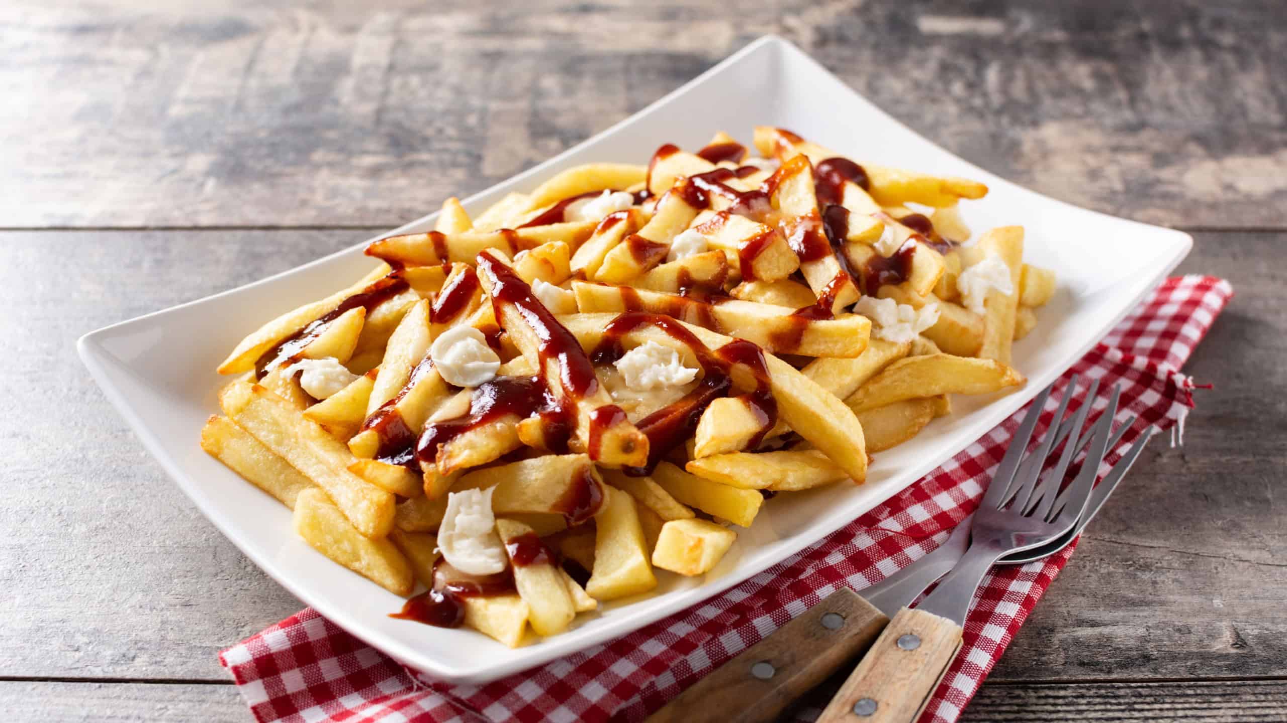 Traditional Canadian Poutine on wooden table