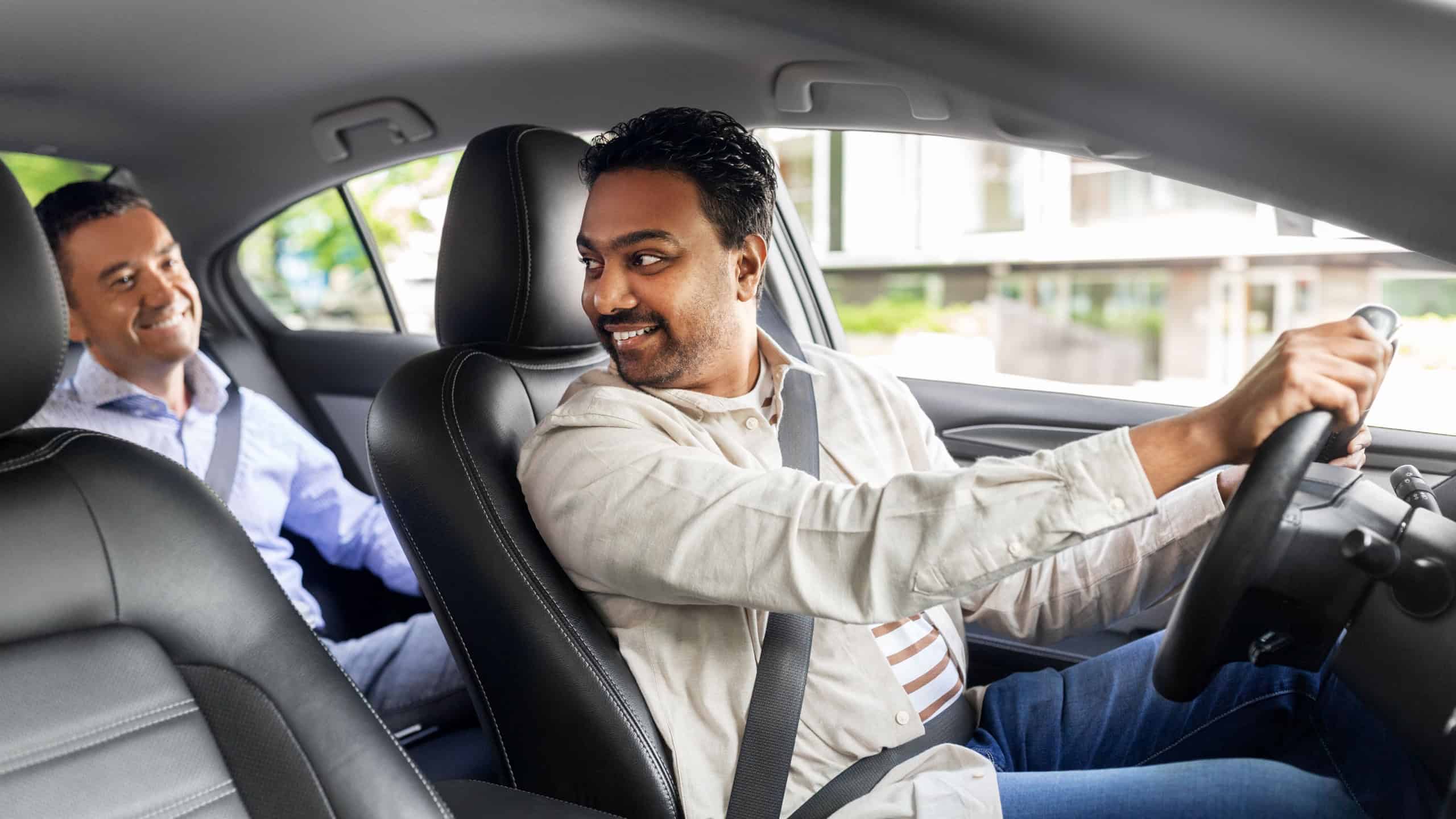 transportation, vehicle and people concept - happy smiling middle aged male passenger talking to taxi car driver