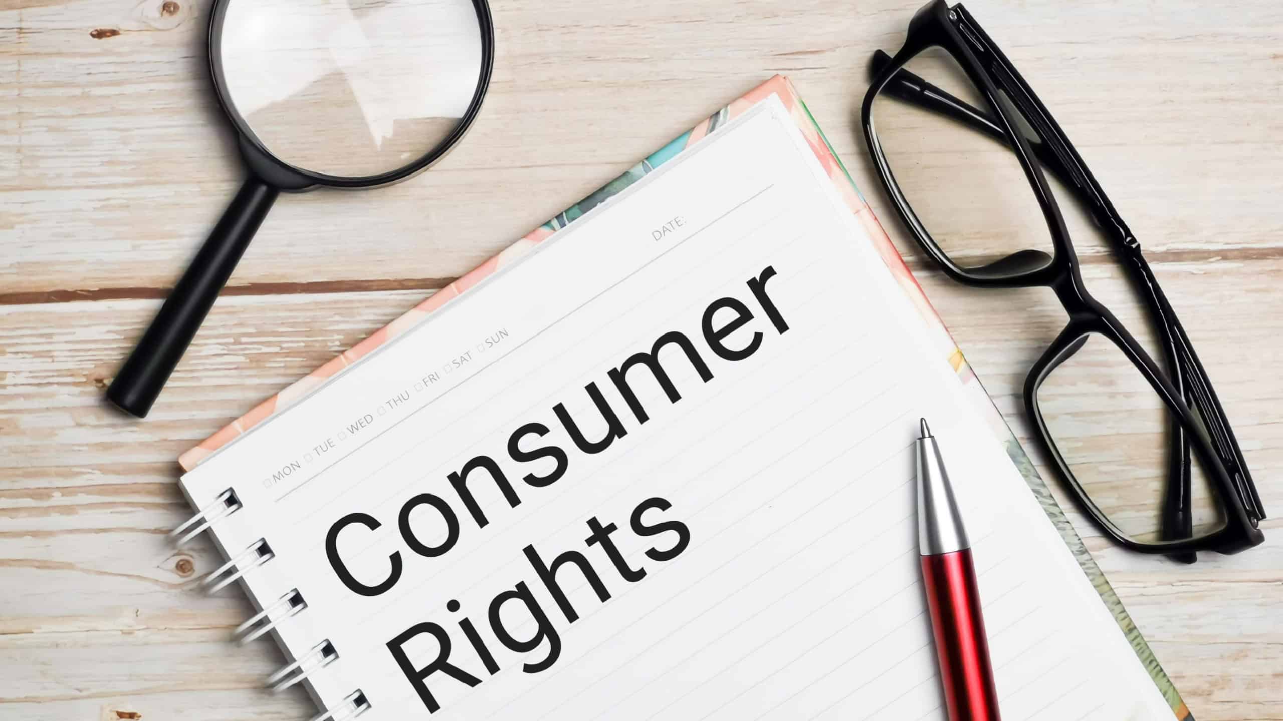 Consumer rights written on note book with pen,magnifying glass and eye glasses.