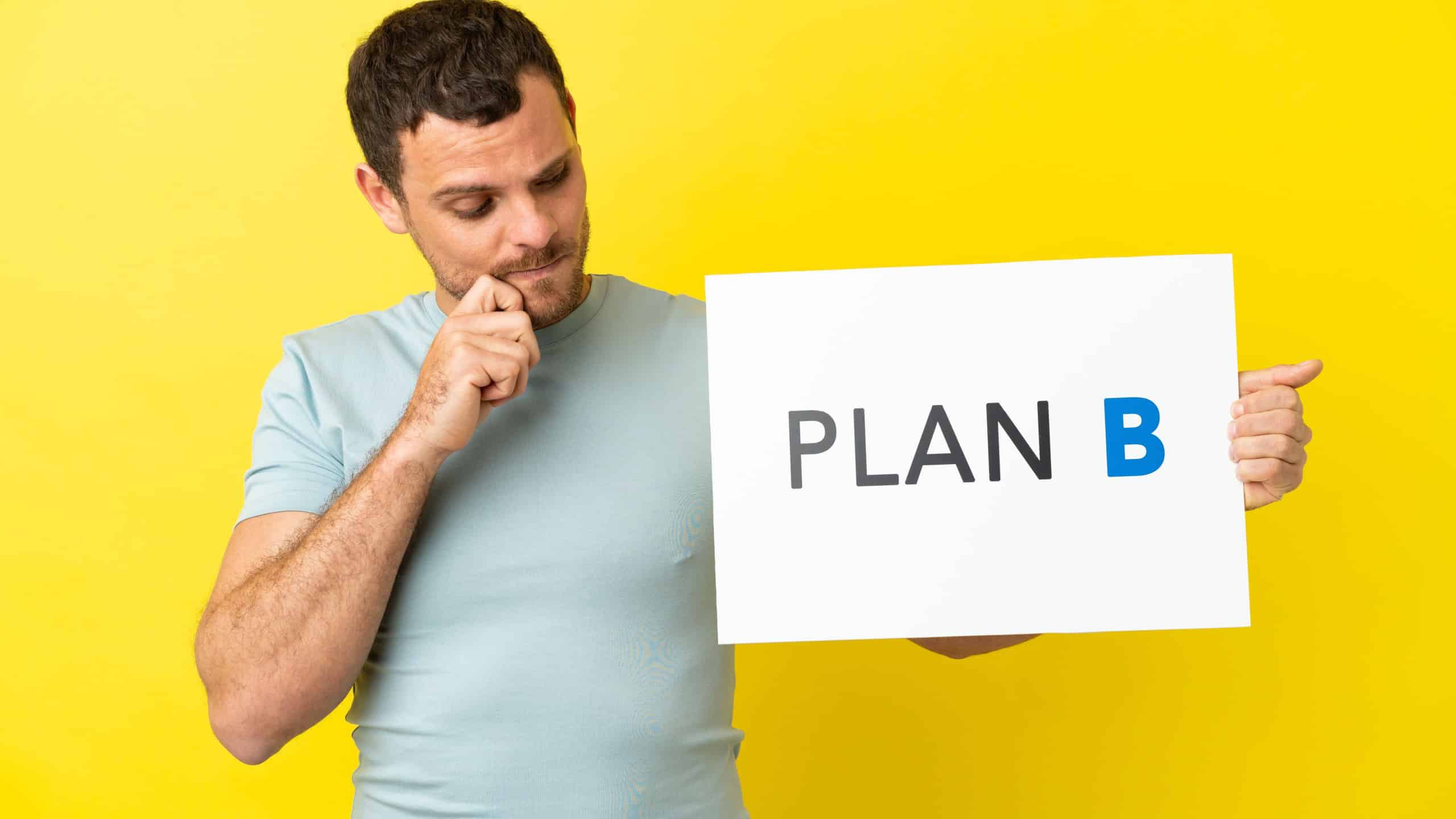 Brazilian man over isolated purple background holding a placard with the message PLAN B and thinking