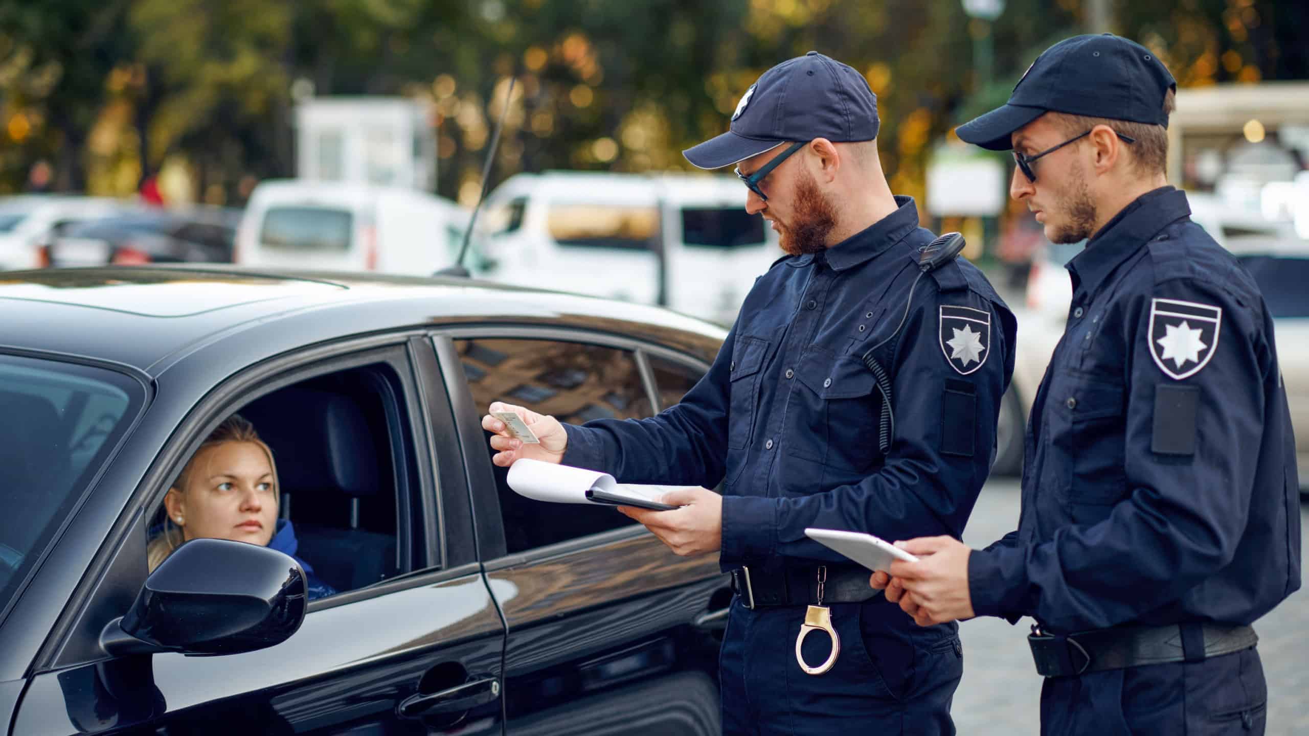Male police officers checking the driving license