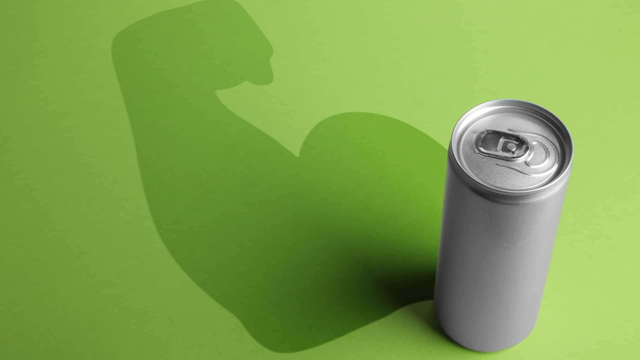 Energy drink and shadow in shape of sportsman's hand silhouette on light green background 