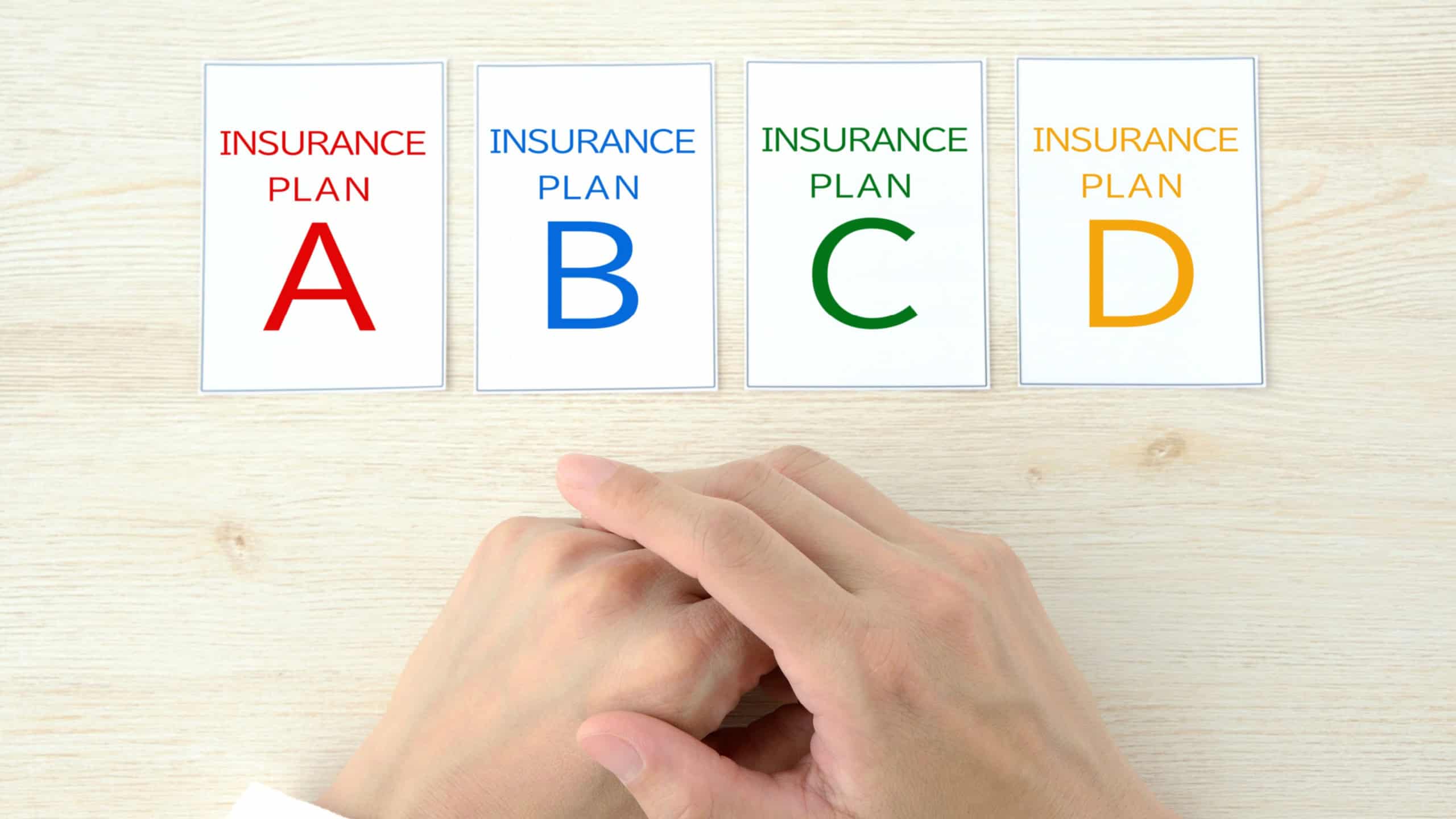 Human's hands and cards with insurance plan A to B words