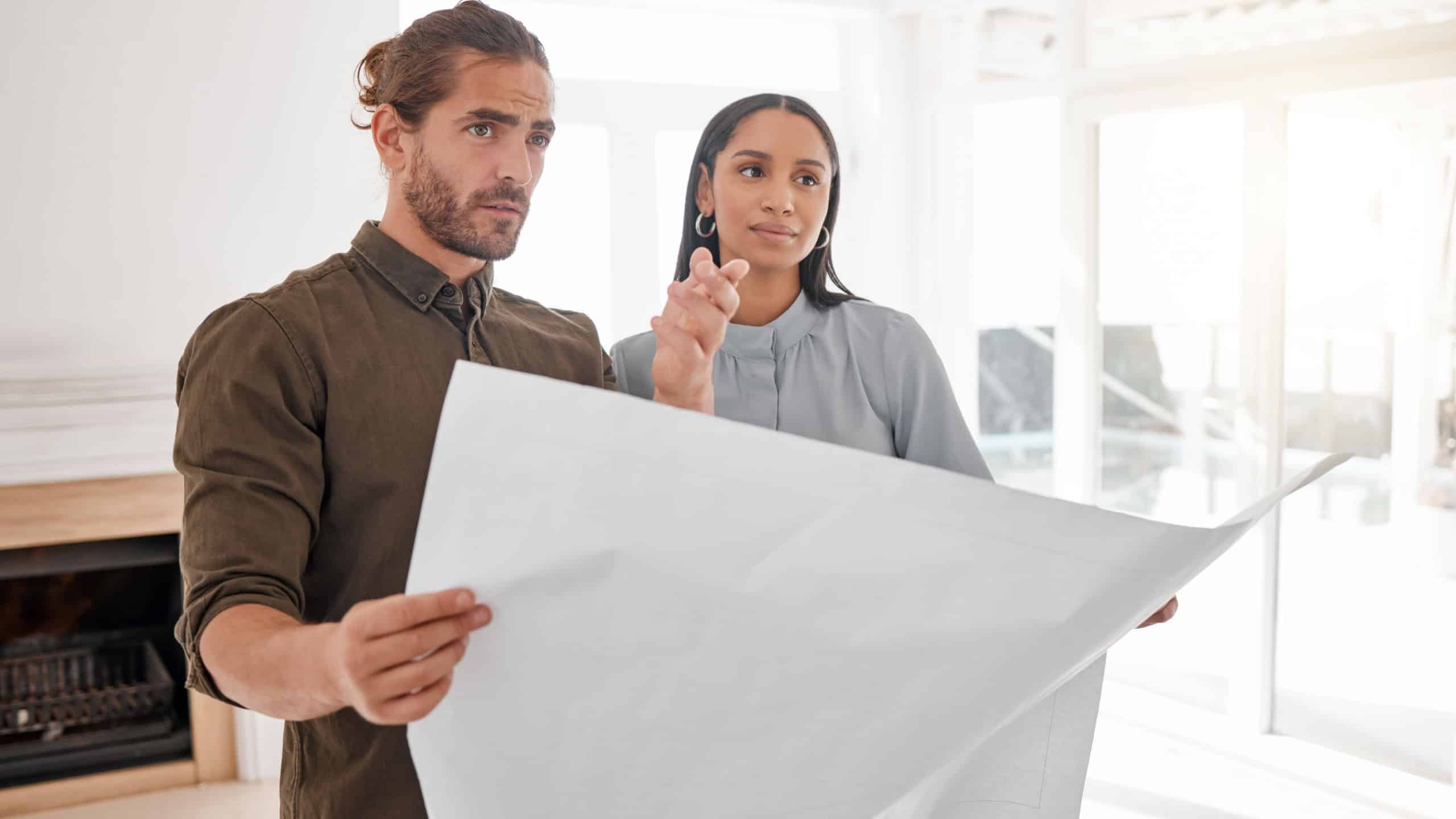 Making dreams a reality. Shot of two young architects looking at building plans on site.