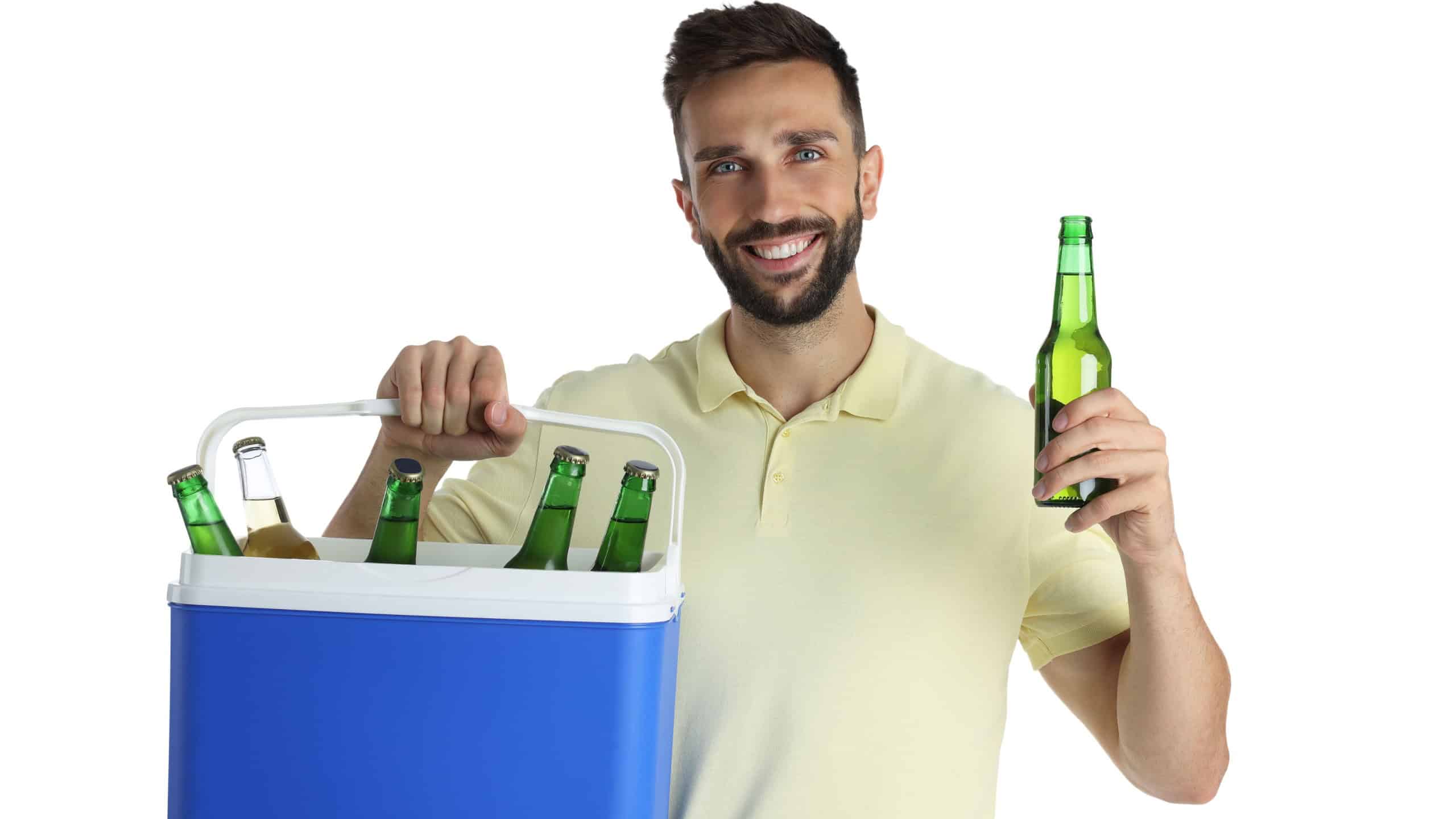 Happy man with cool box and bottles of beer on white background