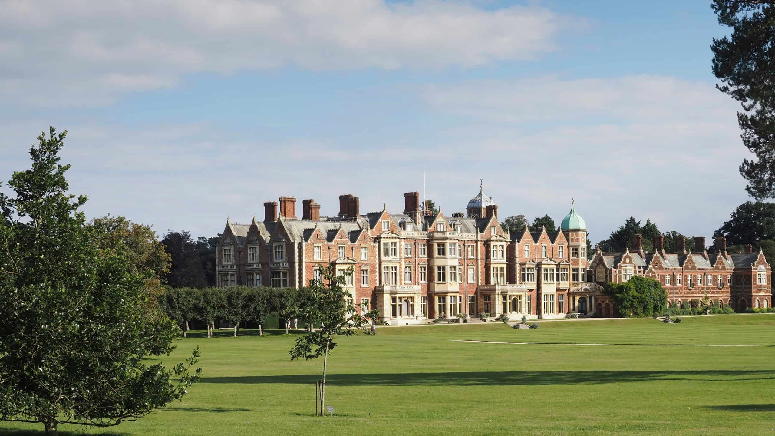 The beautiful Sandringham Estate in England surrounded by green grass and lush trees