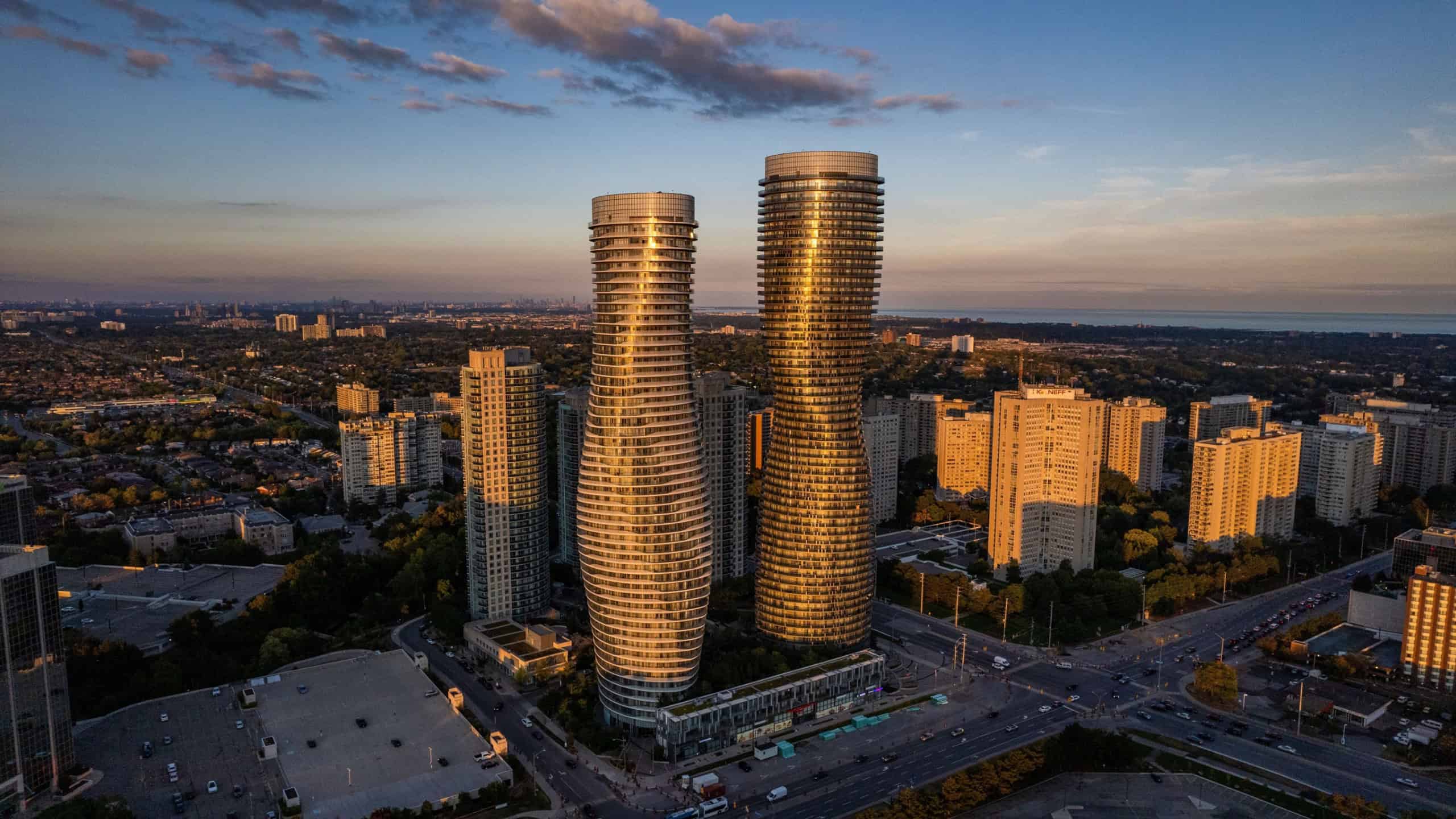 An aerial view of the Absolute world twin tower skyscraper complex in Canada at sunset