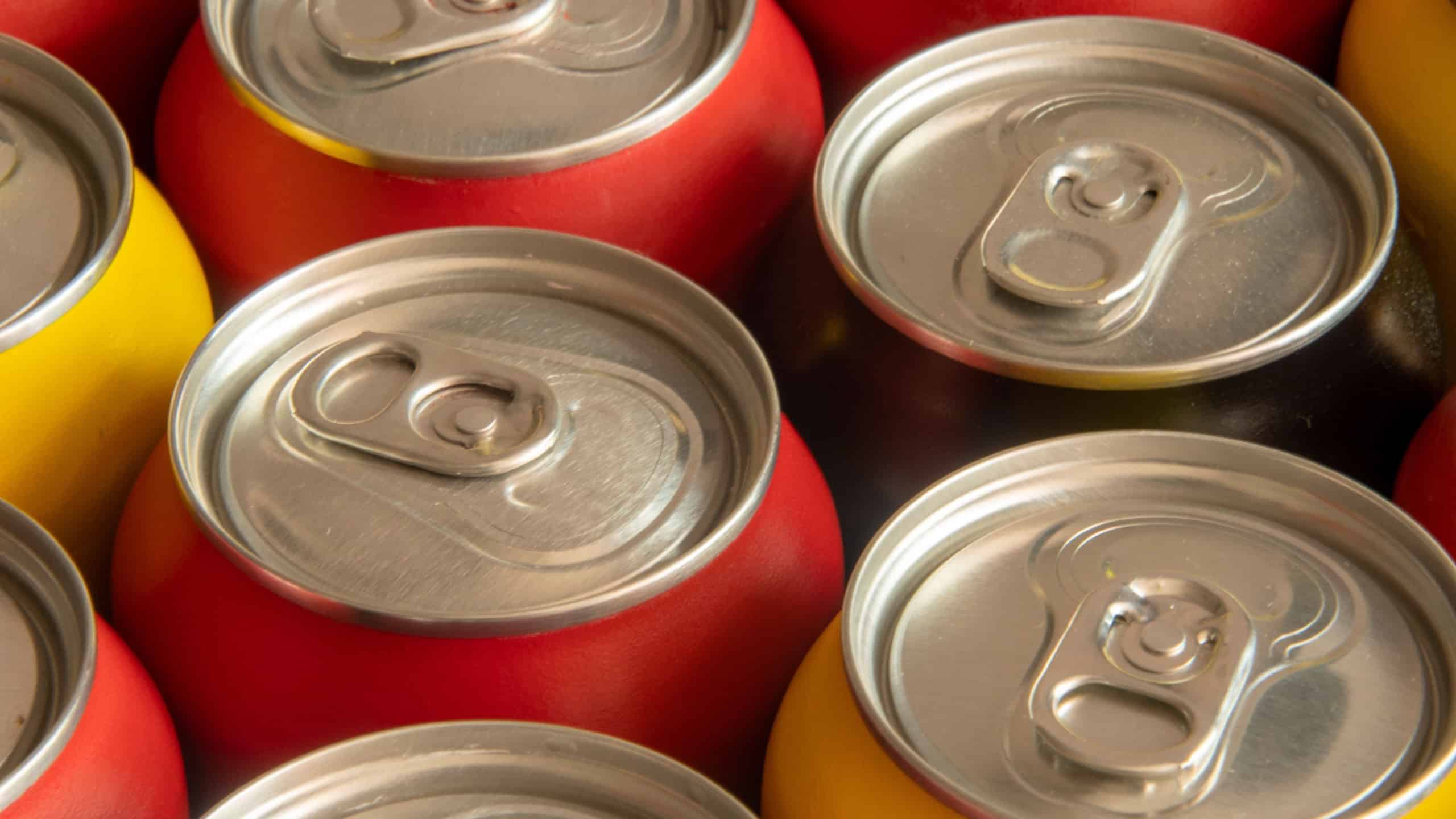 Group of aluminum soda cans of assorted colors forming a mosaic