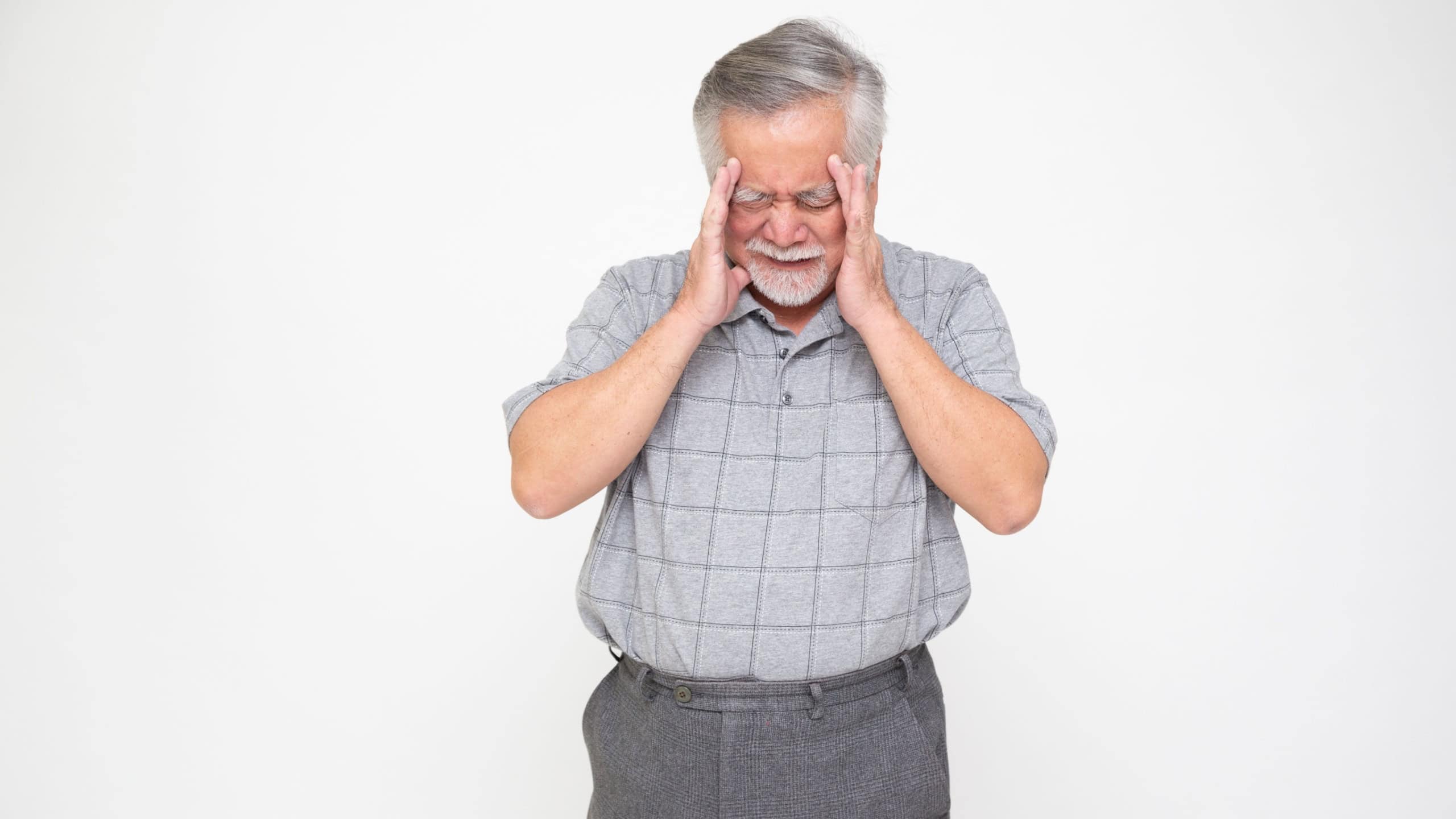 Asian senior man with a headache, dizziness or high blood pressure isolated on white background, Migraine in the elderly concept