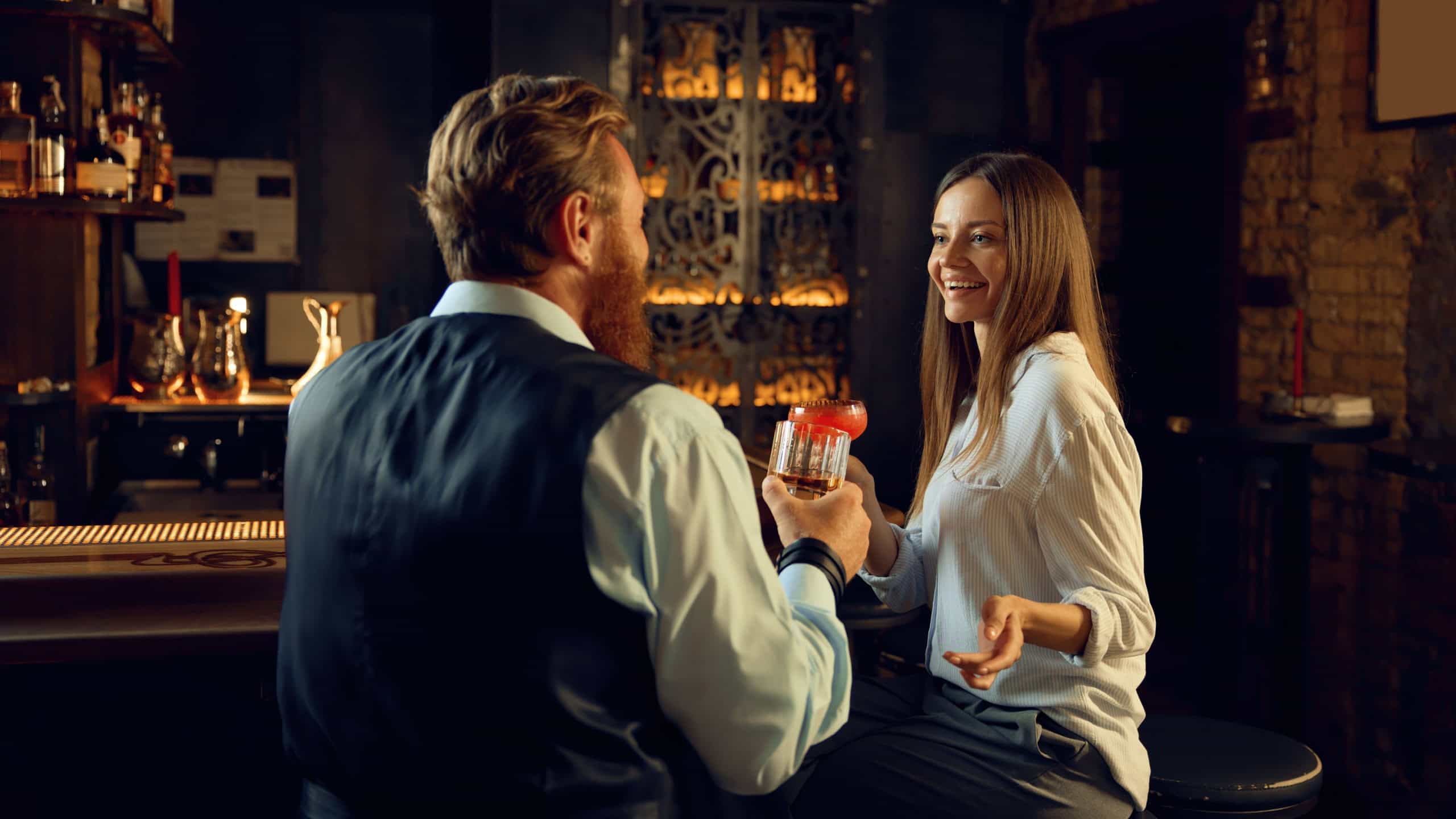 Man and woman having nice conversation at bar counter