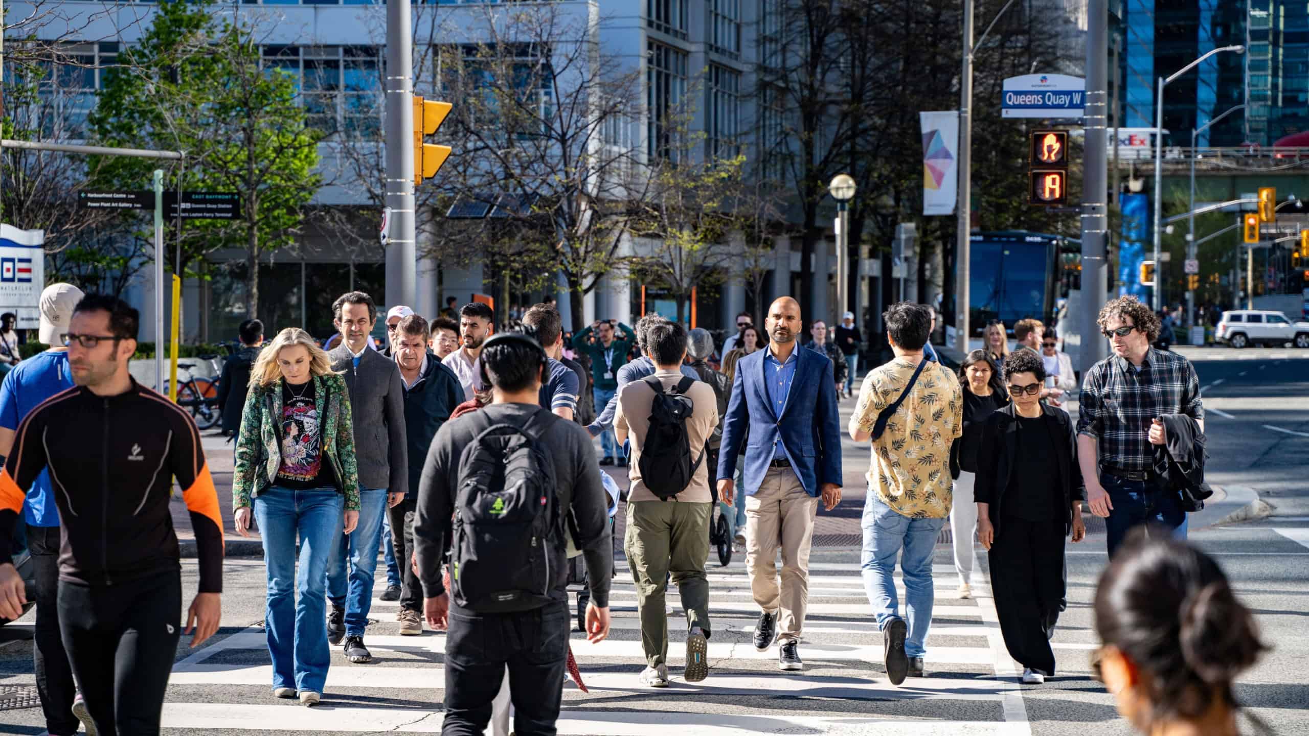 Crowd of people at the crosswalk in Downtown Toronto. Toronto, Canada - April 30, 2024.
