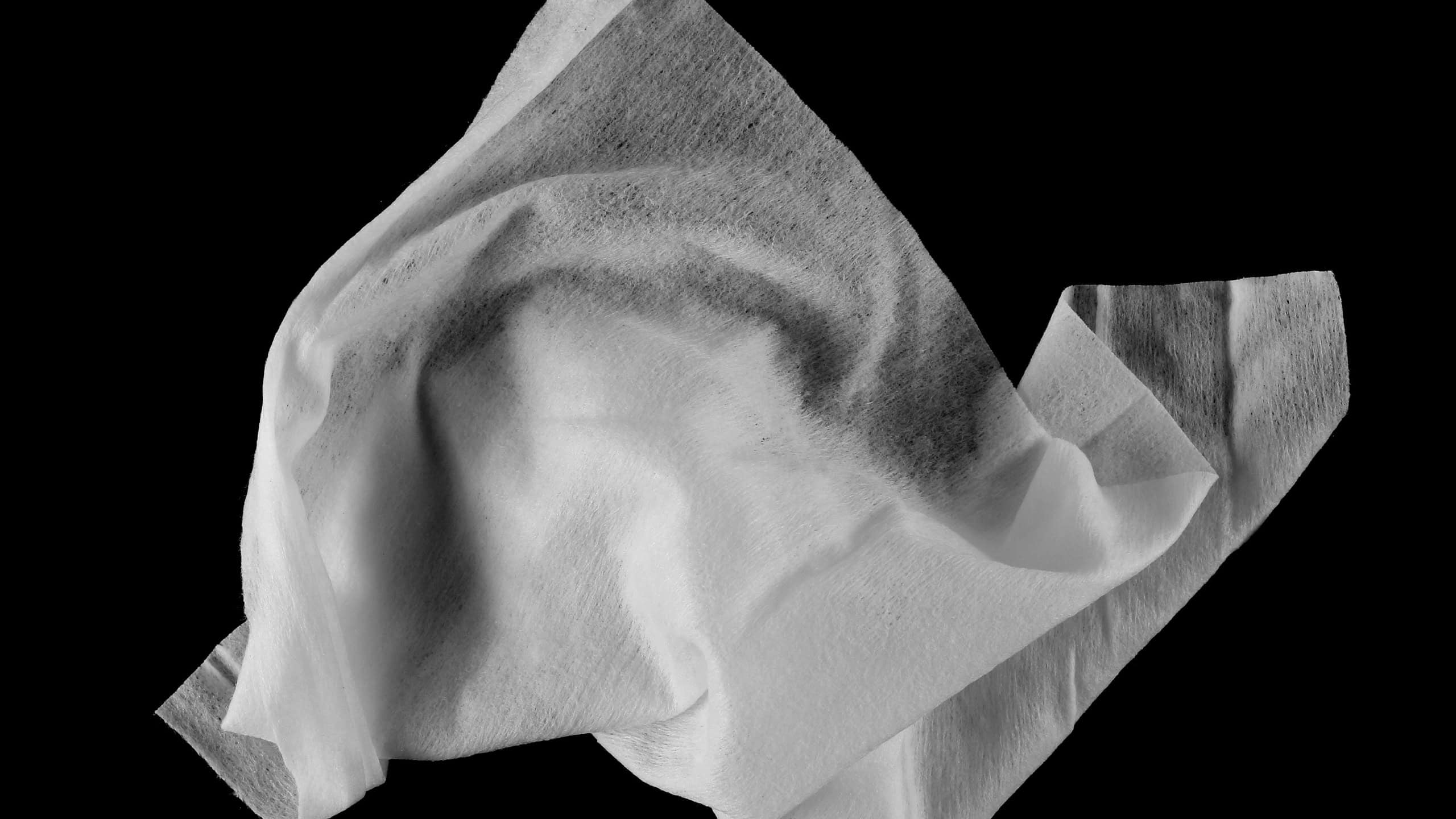 Crumpled tissues, white disposable wet wipes isolated on black, clipping