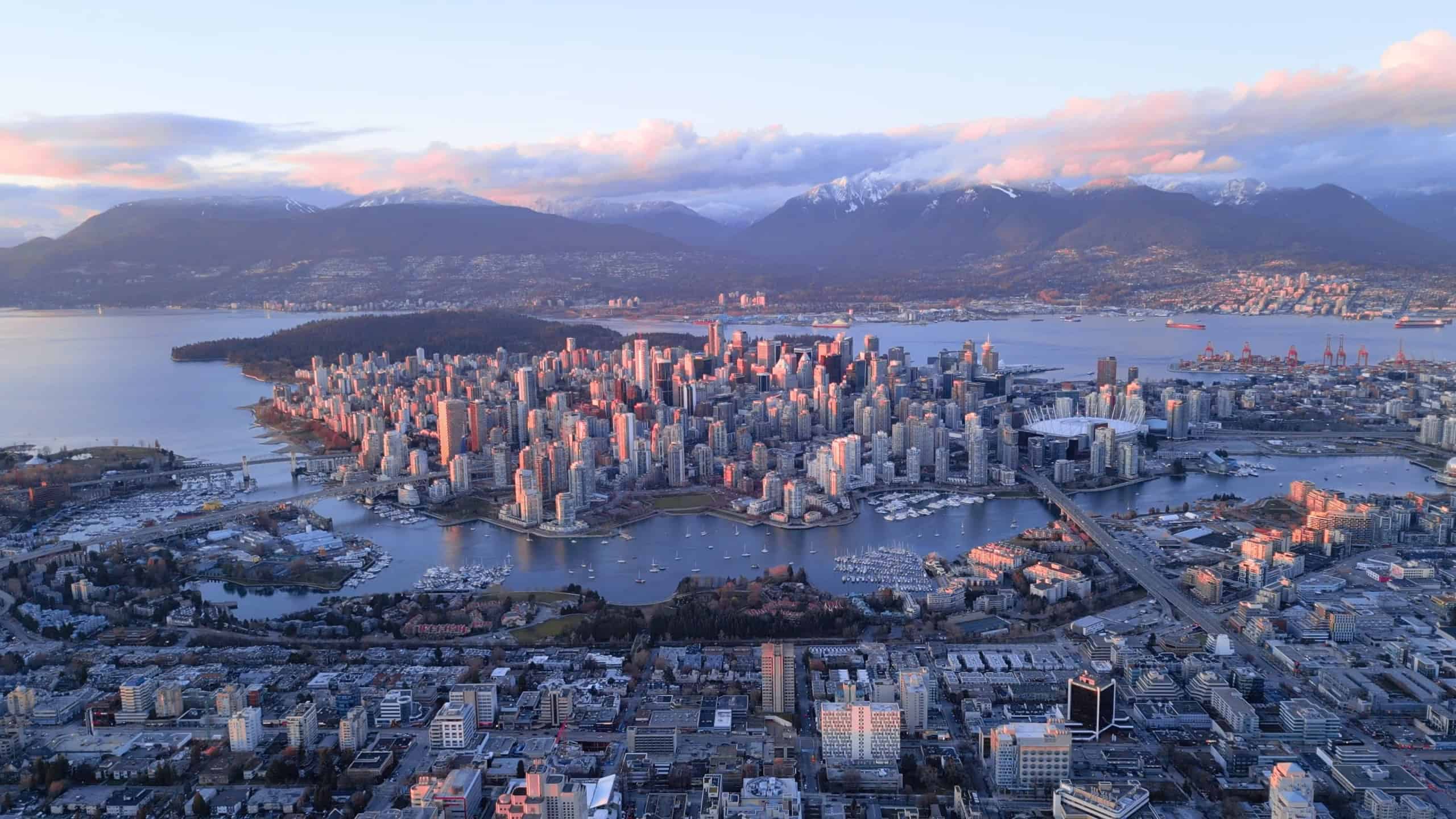Vancouver skyline at sunset with snowy mountains