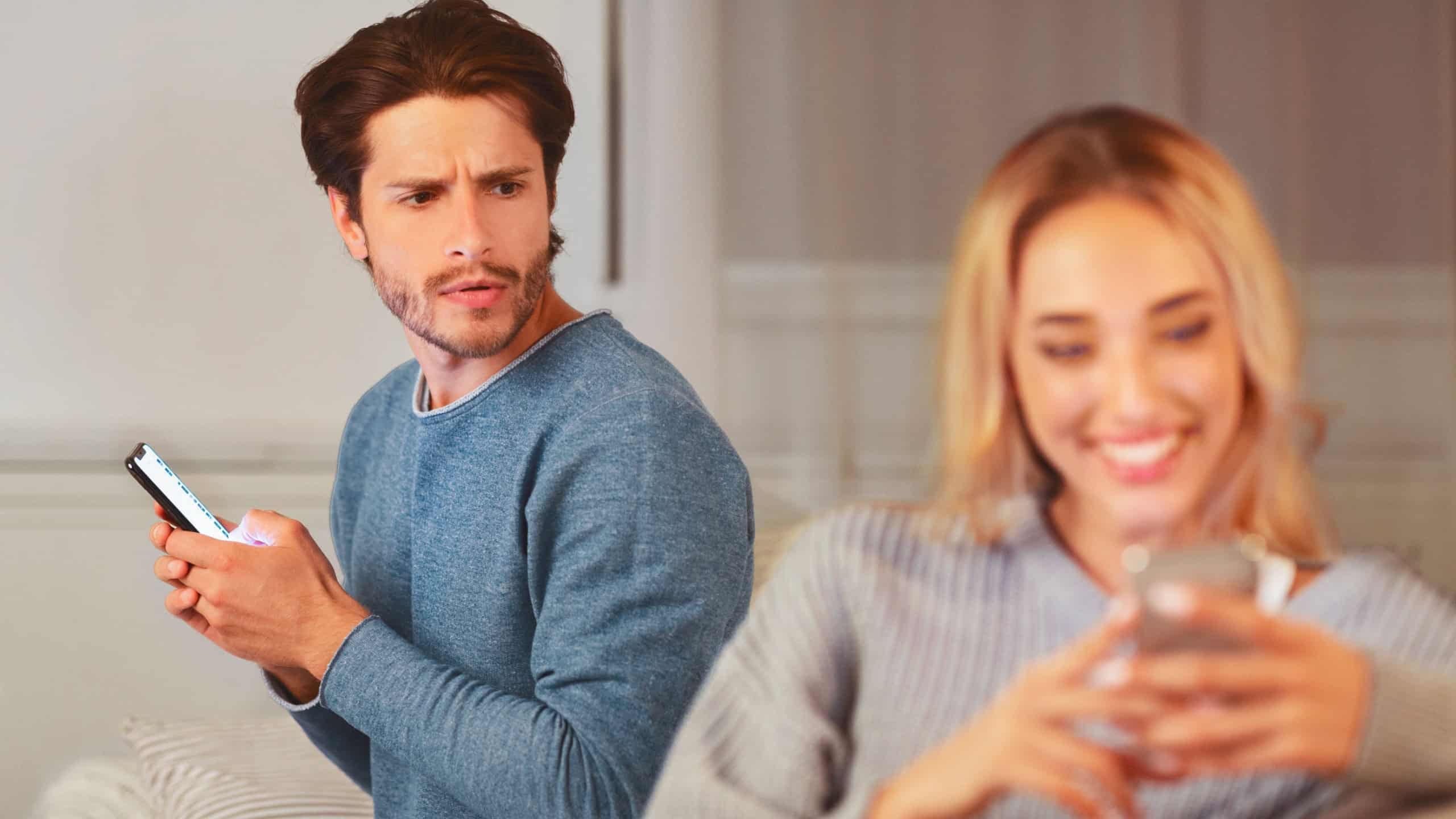 Cheating. Jealous Husband Noticed Wife Texting On Cellphone Suspecting Infidelity At Home.