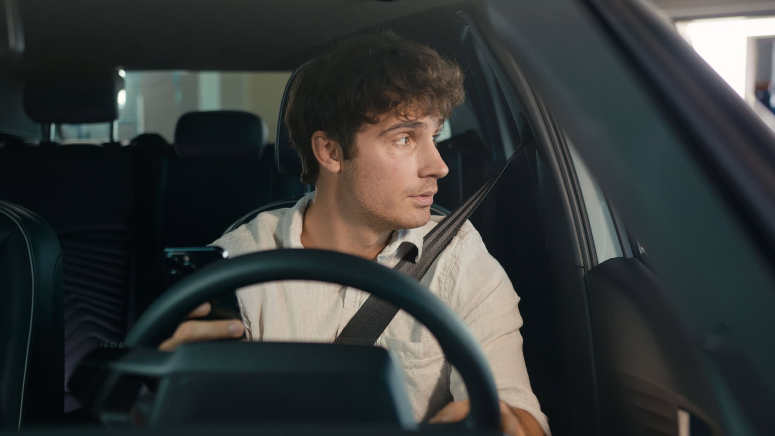 Tired puzzled upset worry anxiety Caucasian man driver male guy sit in car auto businessman frustrated thinking looking at window of automobile holding mobile phone stressed business problem bad news
