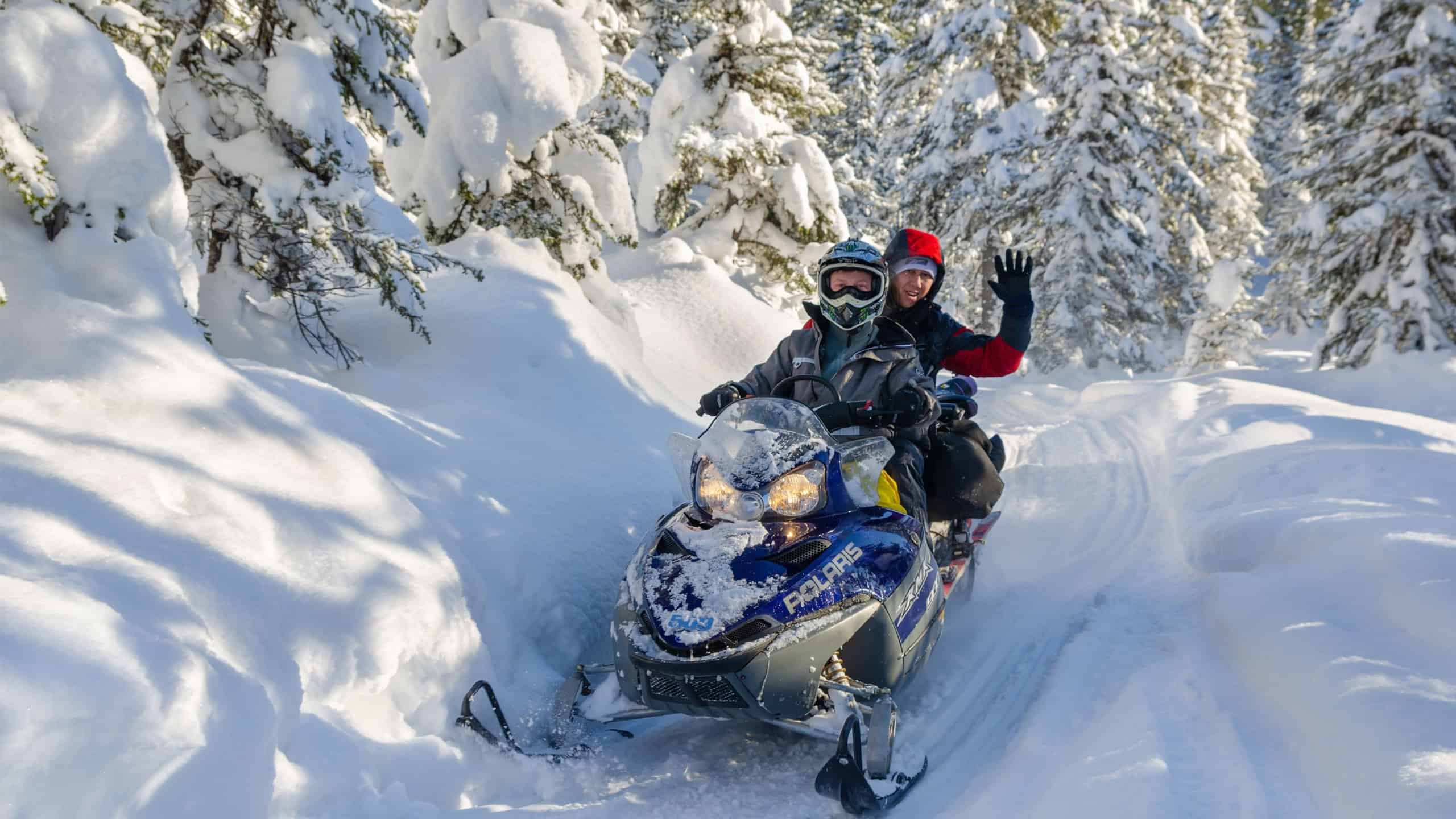 Unidentified men ride on a snowmobile on Mamai mount, a popular snow sports resort on Lake Baikal. 