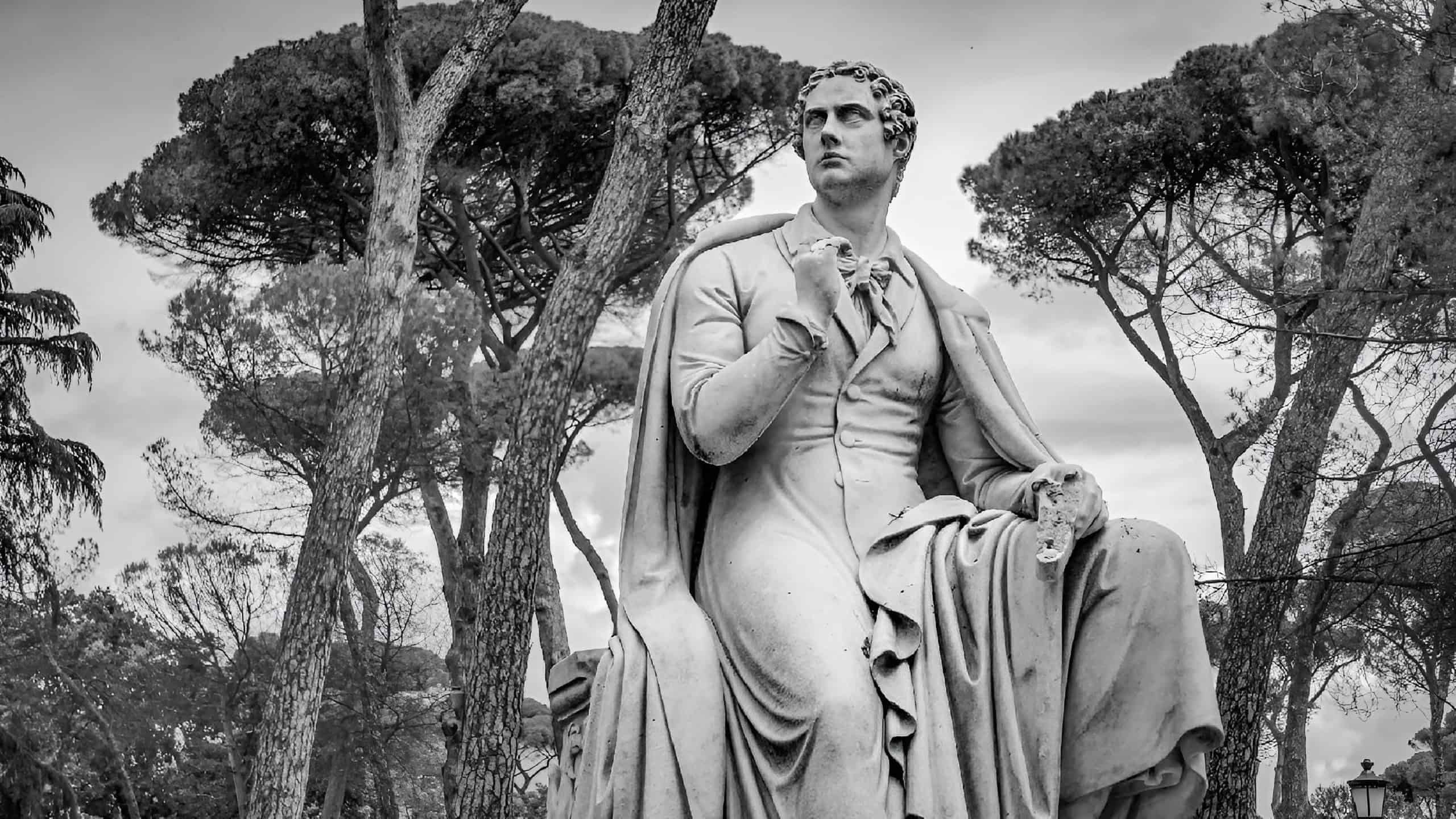ROME, IT - May 12, 2023: Statue of Lord Byron in black and white, Rome, italy. A man sits on a grand monument in the park.