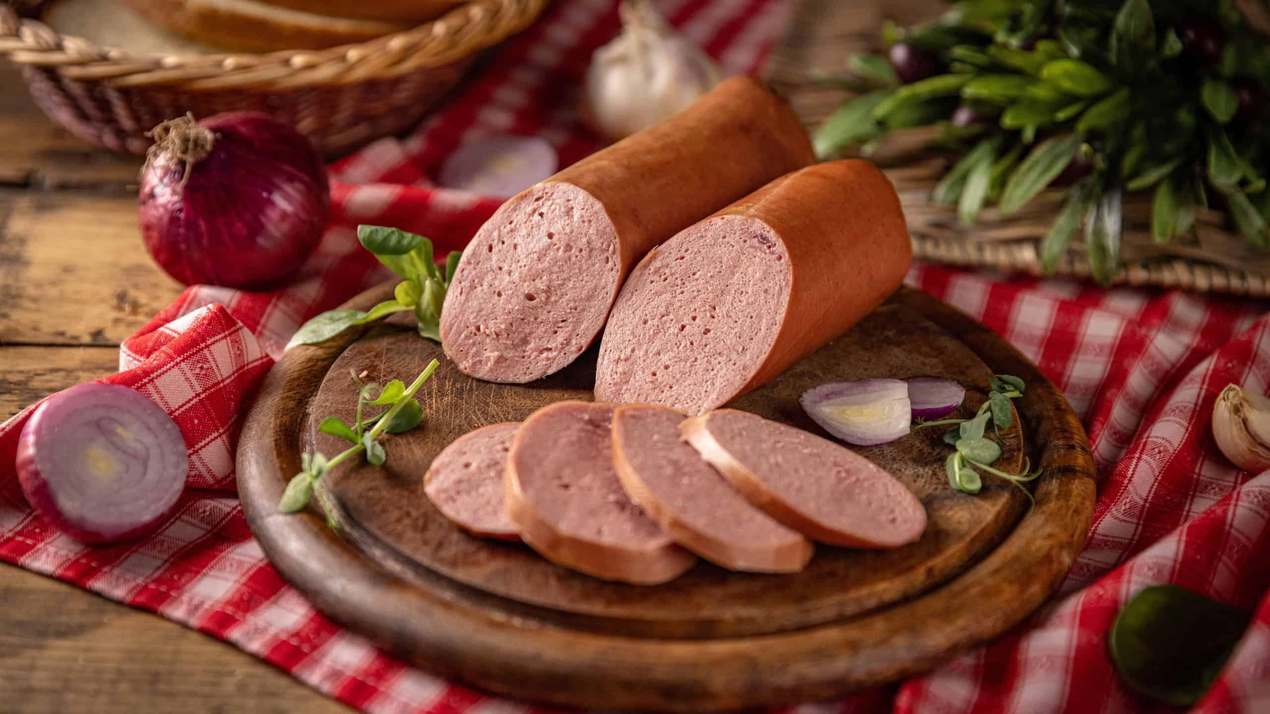 Sliced cold cuts with red onions, garlic, herbs and bread