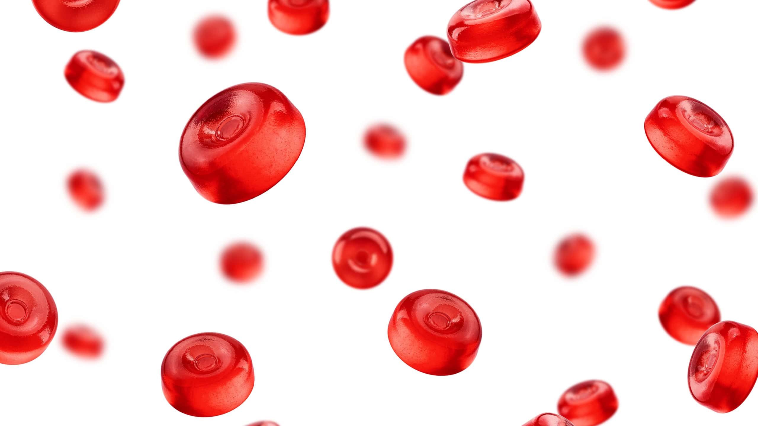 Falling Hard Candy, red fruit caramel, isolated on white background, selective focus