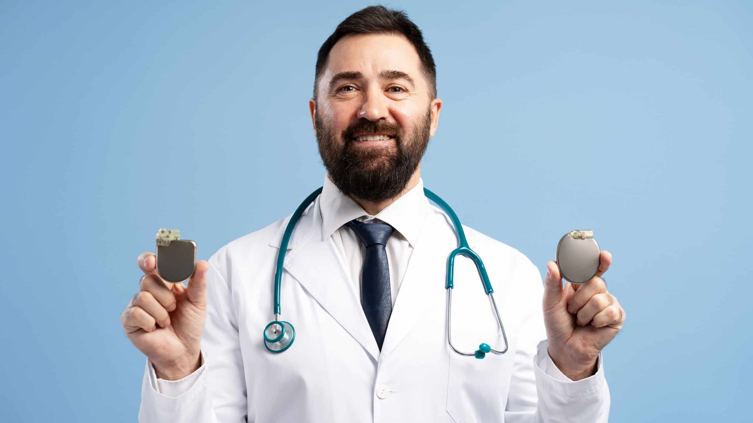 Cardiologist presenting two pacemakers, highlighting advancements in cardiac care and treatment options for heart conditions
