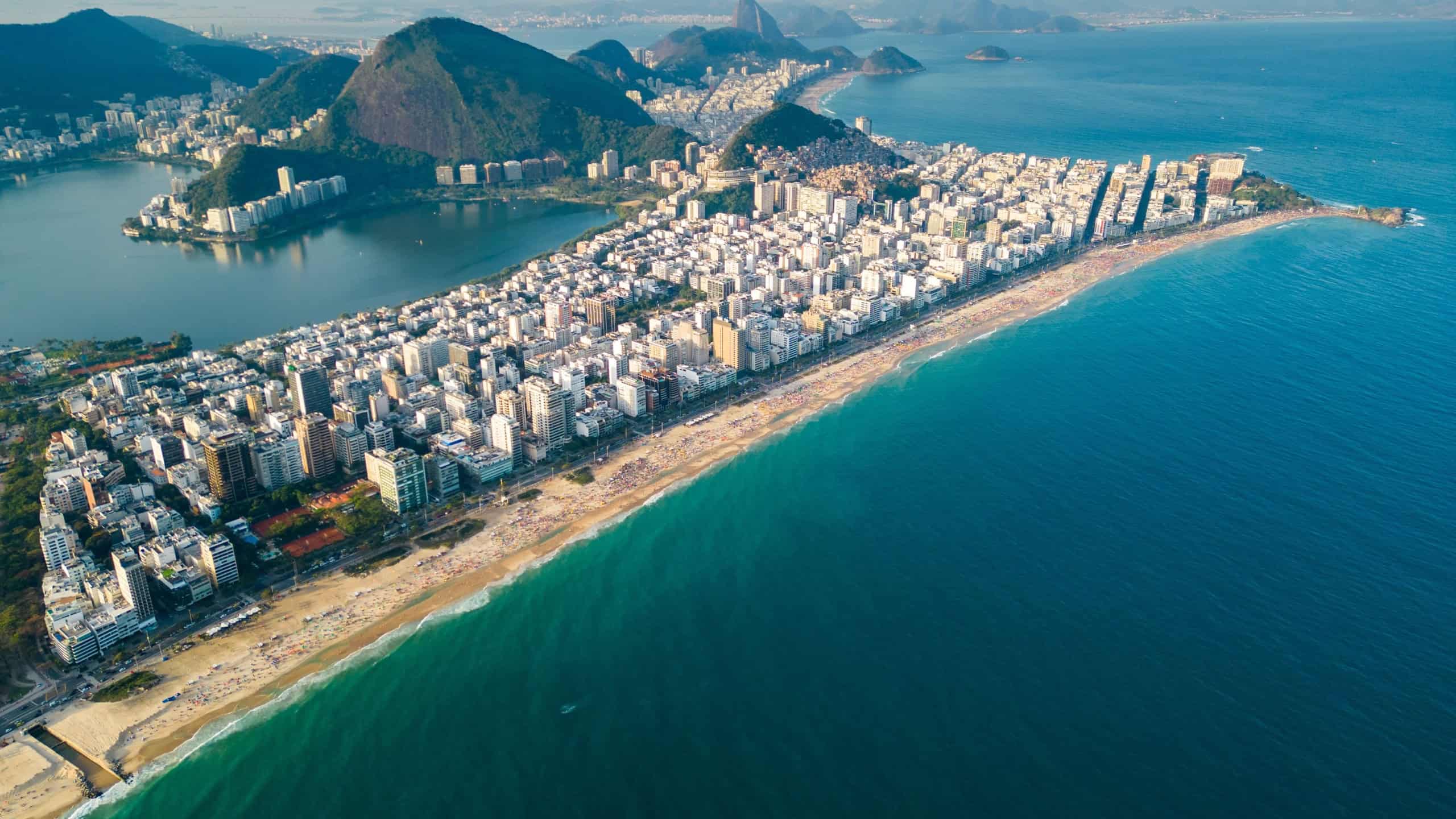Aerial View of Ipanema Beach With Apartment Buildings in Front and Mountains Behind in Rio de Janeiro, Brazil