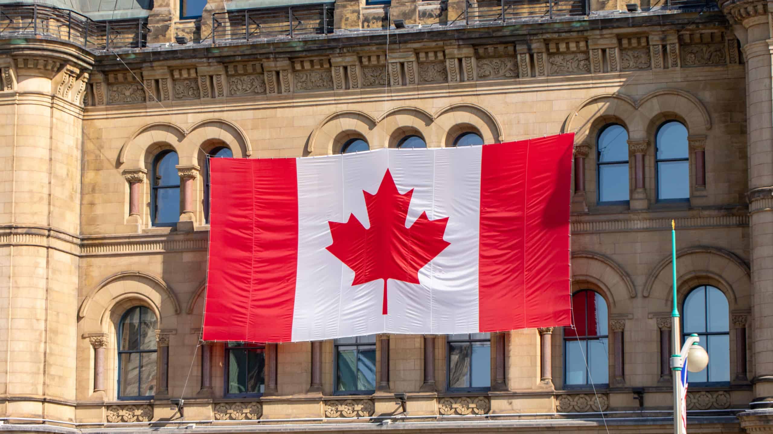 Canada Day in downtown Ottawa. Canadian flag on government building in capital city. Office of the Prime Minister and Privy Council.