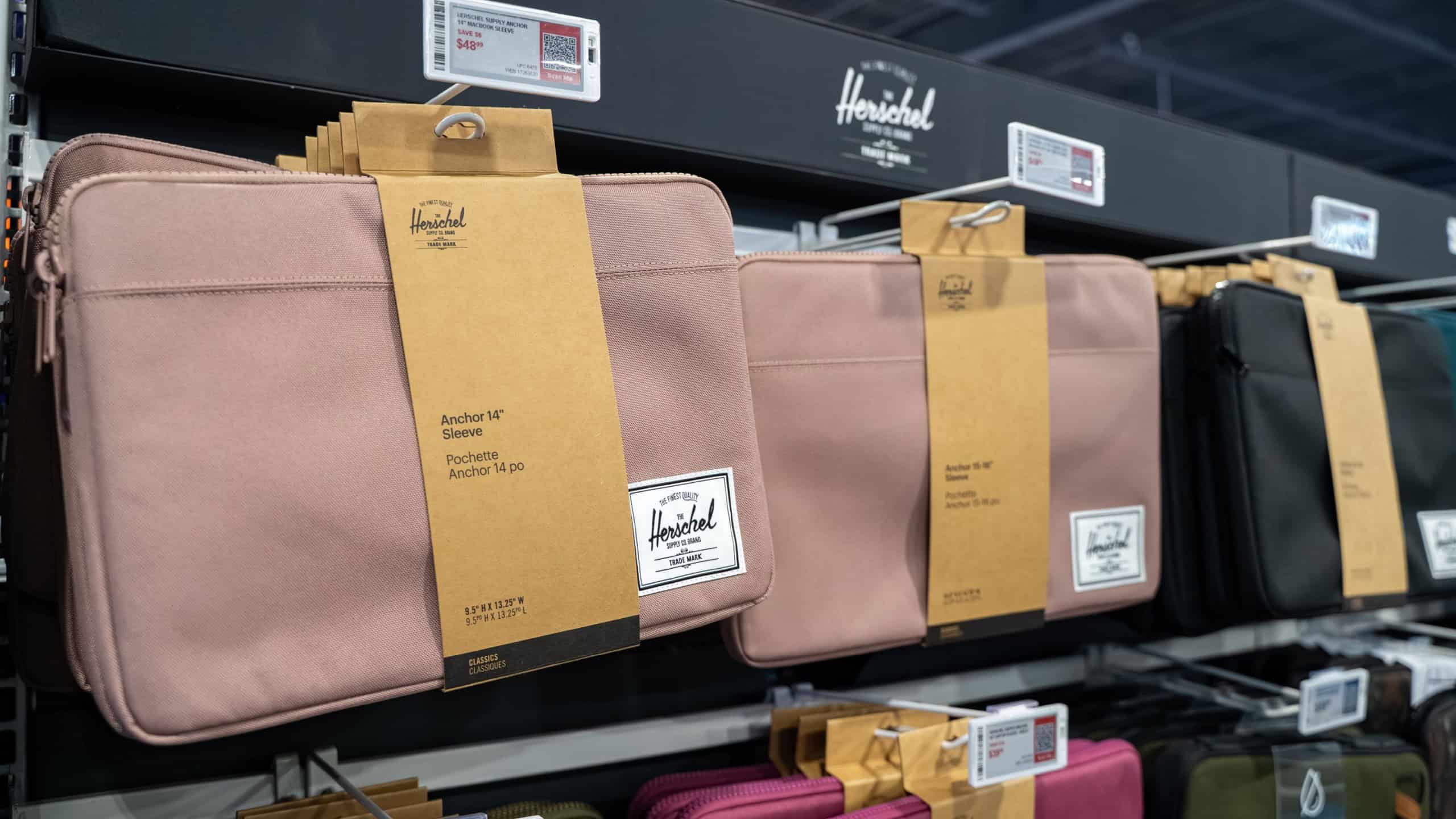 View of Herschel laptop sleeves on retail shelf. Toronto, Canada - December 3, 2025.