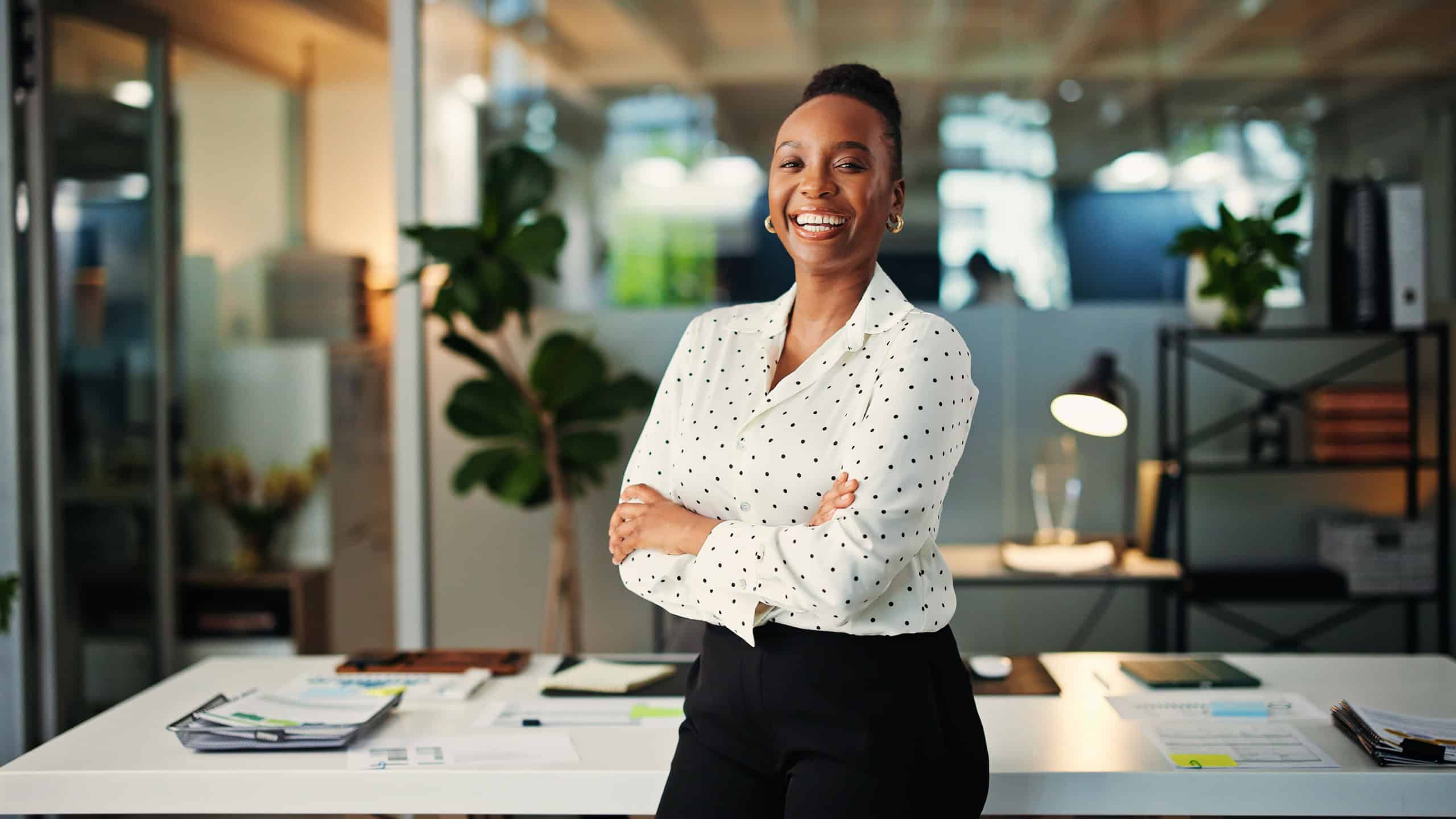 Office, portrait and woman with arms crossed, smile or financial analyst with career growth or pride. Confident, employee and black person with ambition for wealth management and excited in Nigeria