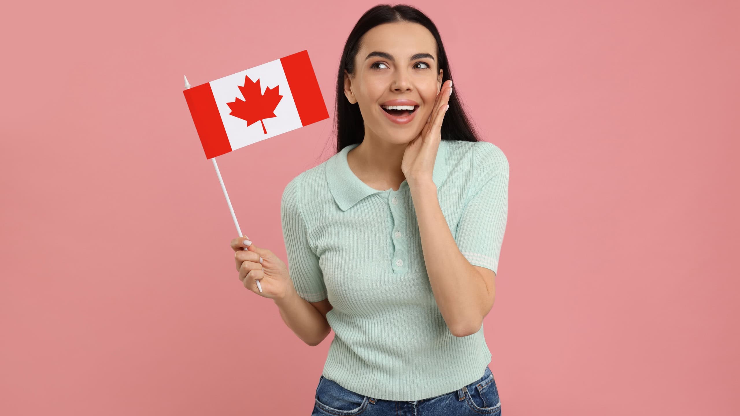 Happy woman with flag of Canada on pink background