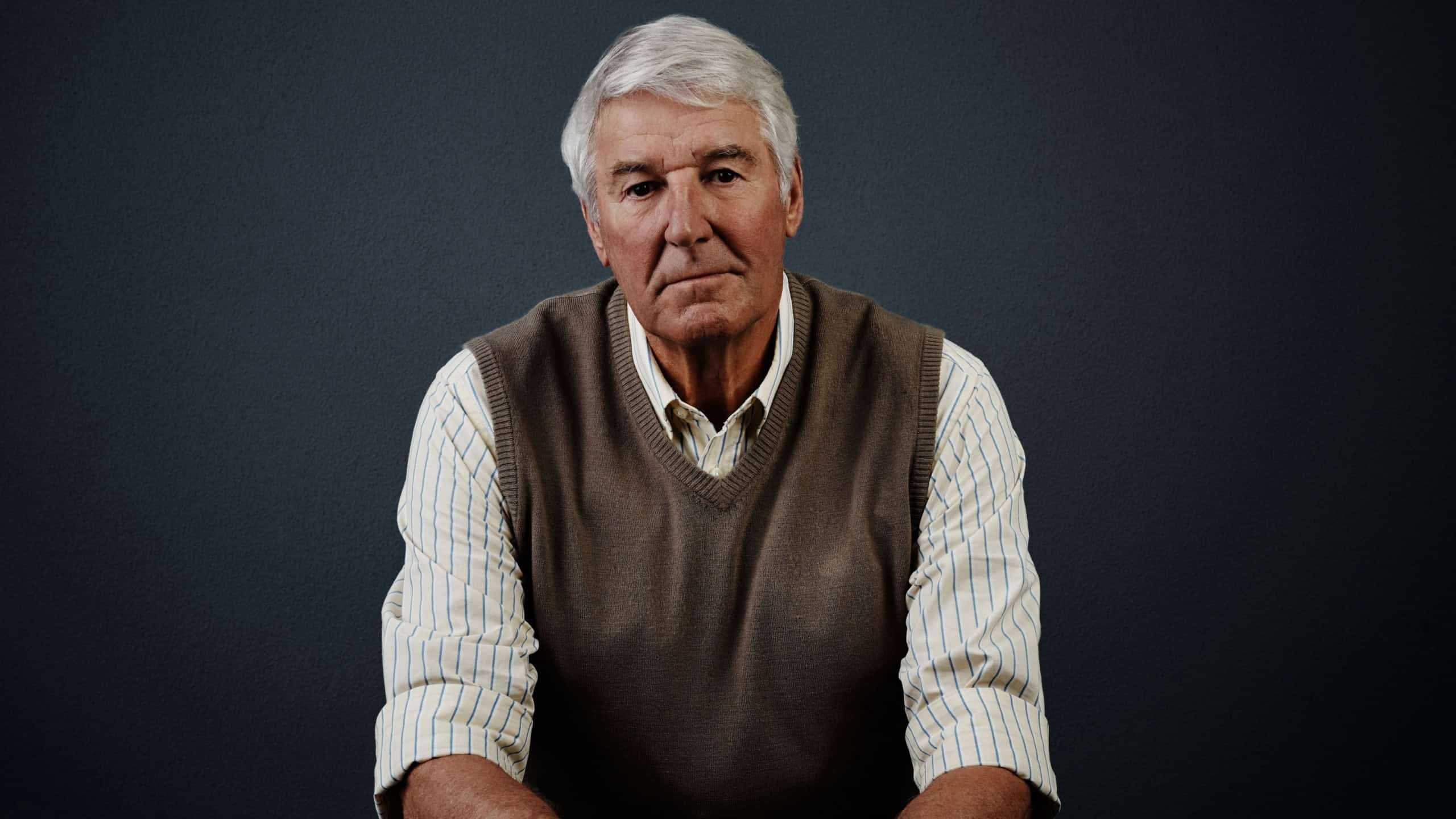 Mental health, portrait and retirement with old man on dark background for psychology or wellness. Calm, healthcare and reflection with senior person in studio for alzheimer or dementia awareness