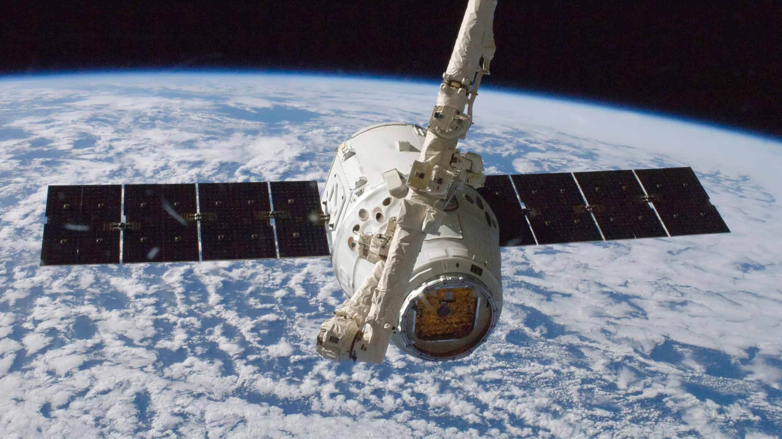The SpaceX Dragon commercial cargo craft is grappled by the International Space Station's Canadarm2 robotic arm. Oct 10th, 2012. - Space exploration photo.