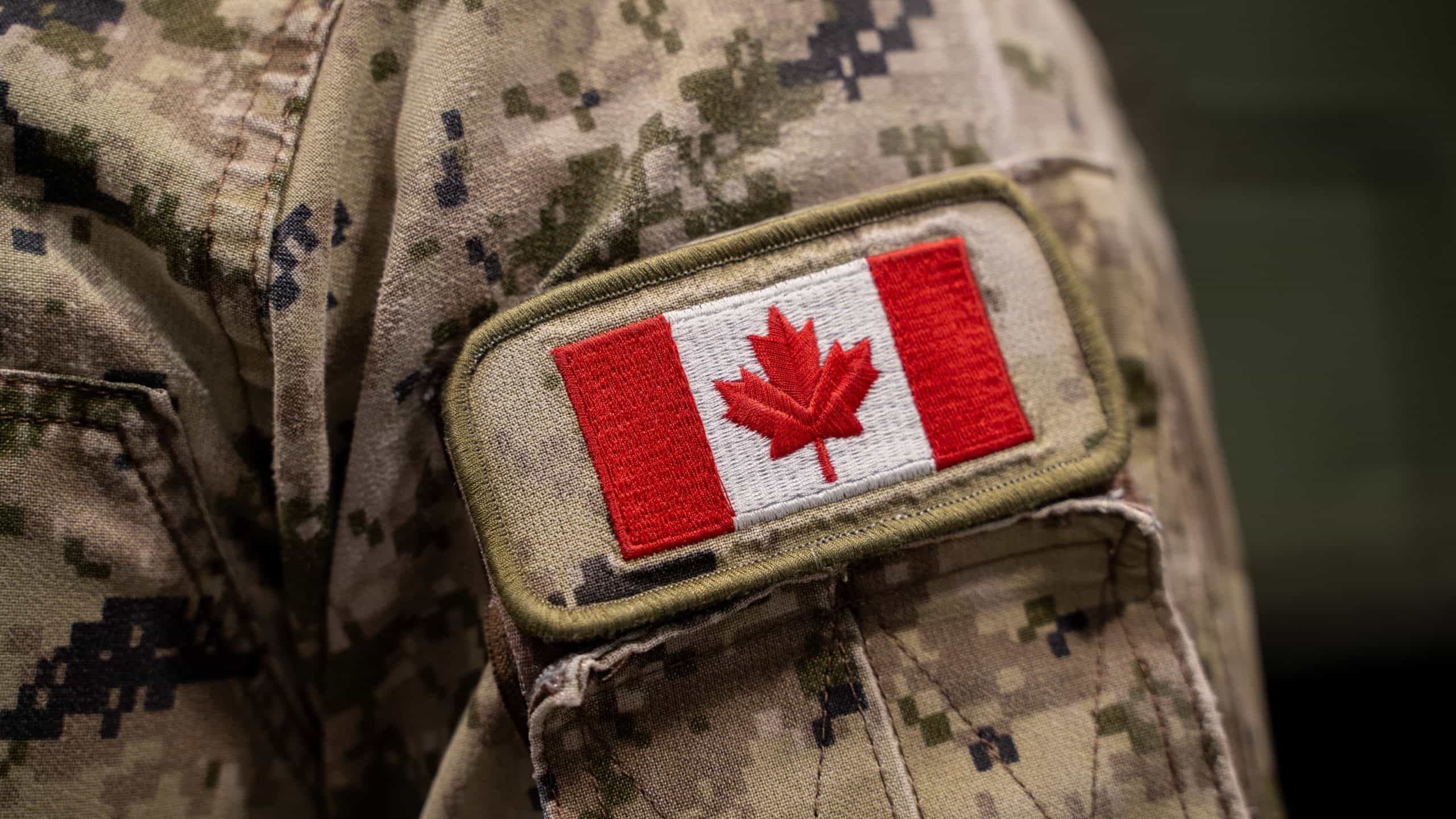 Close up of Canadian flag patch on military uniform.