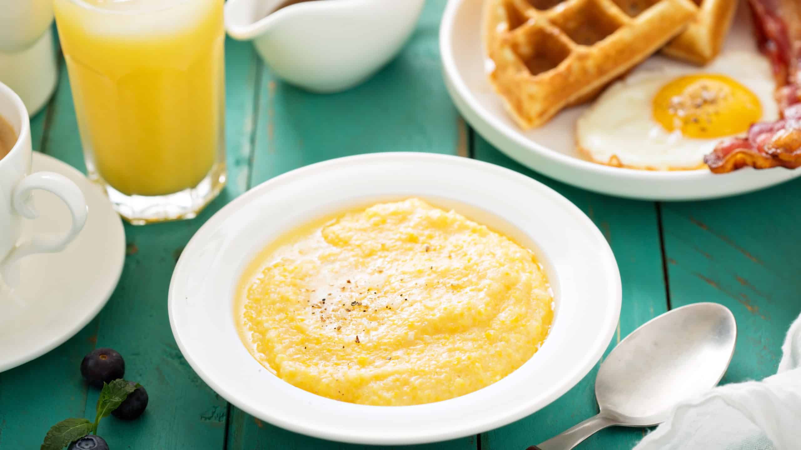 Cheesy grits with butter in a white bowl for breakfast
