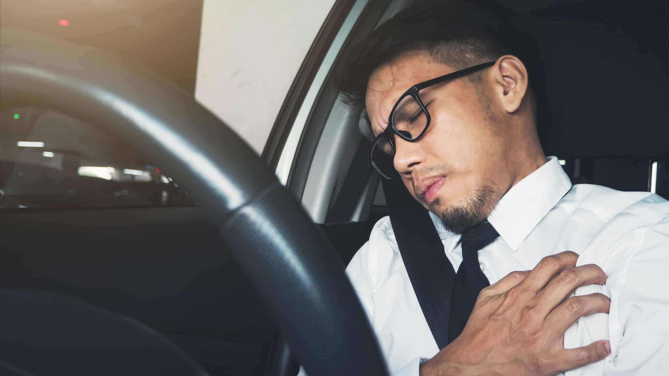 Illness, exhausted, disease, tired for overworked concept. Asian businessman having heart attack while he driving car.