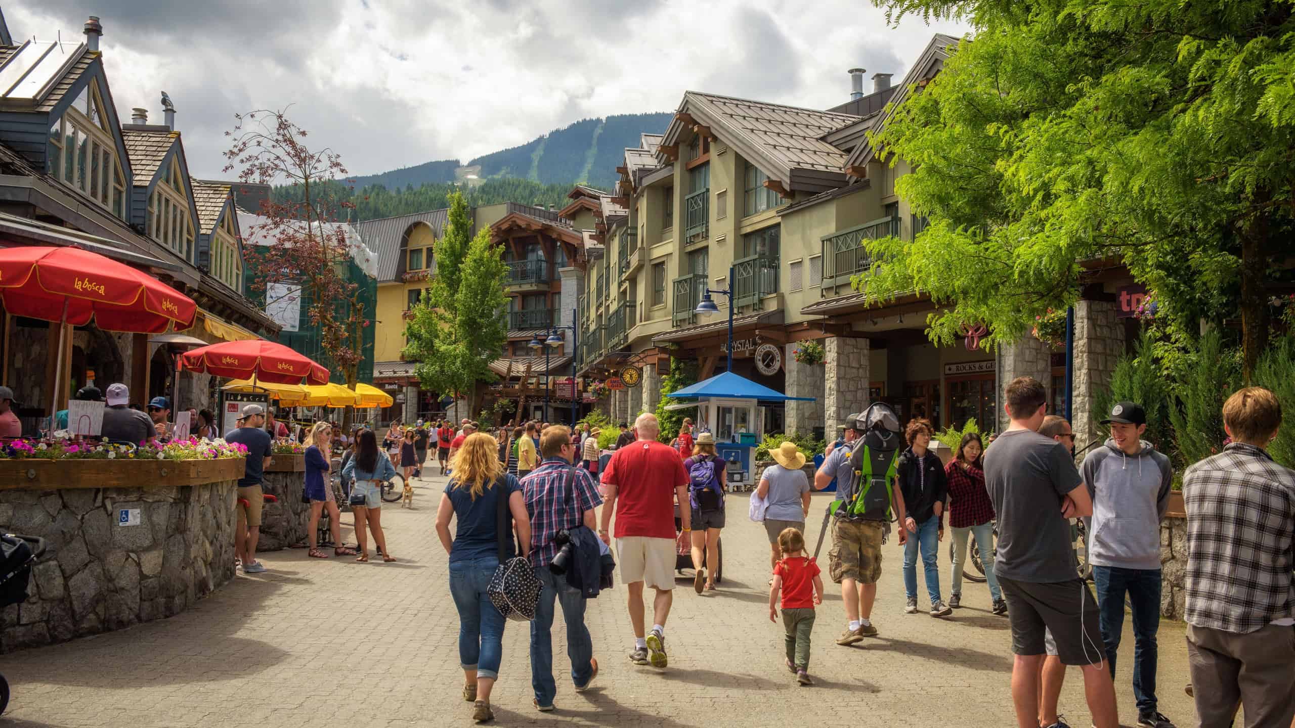  Scenic street view with many tourists in Whistler Village. Whistler is a canadian resort town visited by over 2 million people annually.