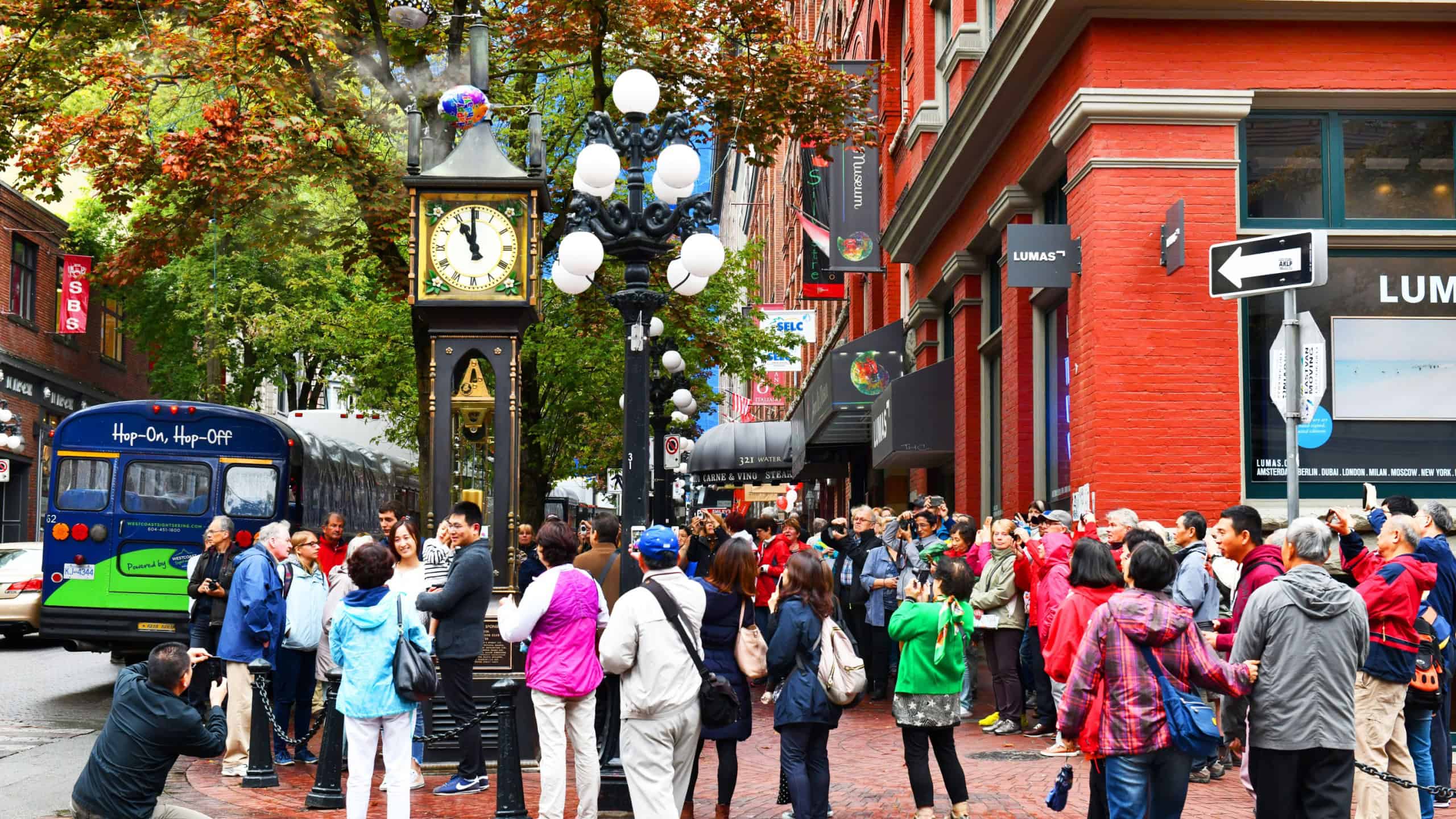 Vancouver BC, Canada - September 25, 2017 :Tourists gather around Steam Clock sound the hour in Vancouver's historic Gastown district