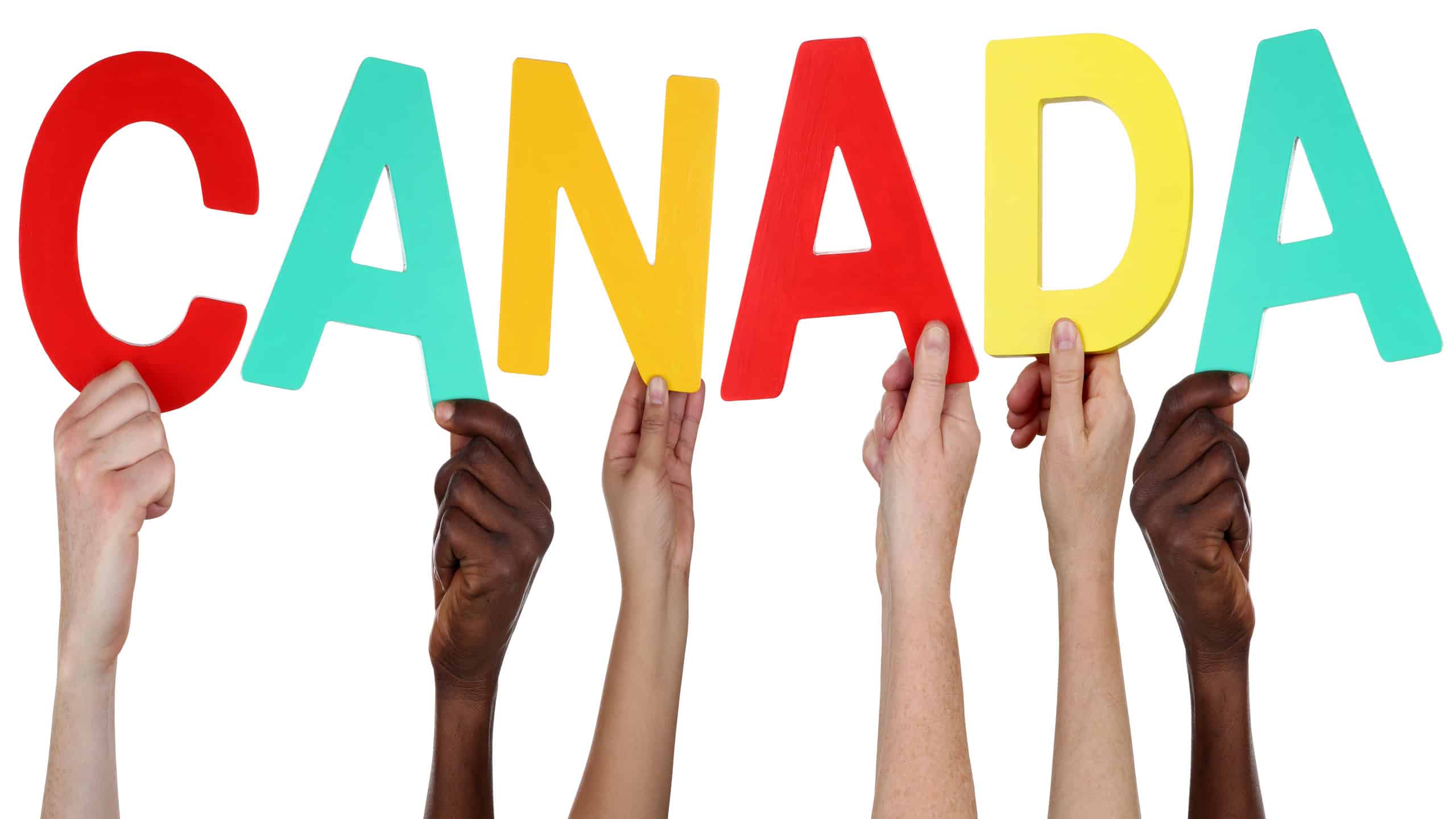 Multi ethnic group of people holding the word Canada isolated