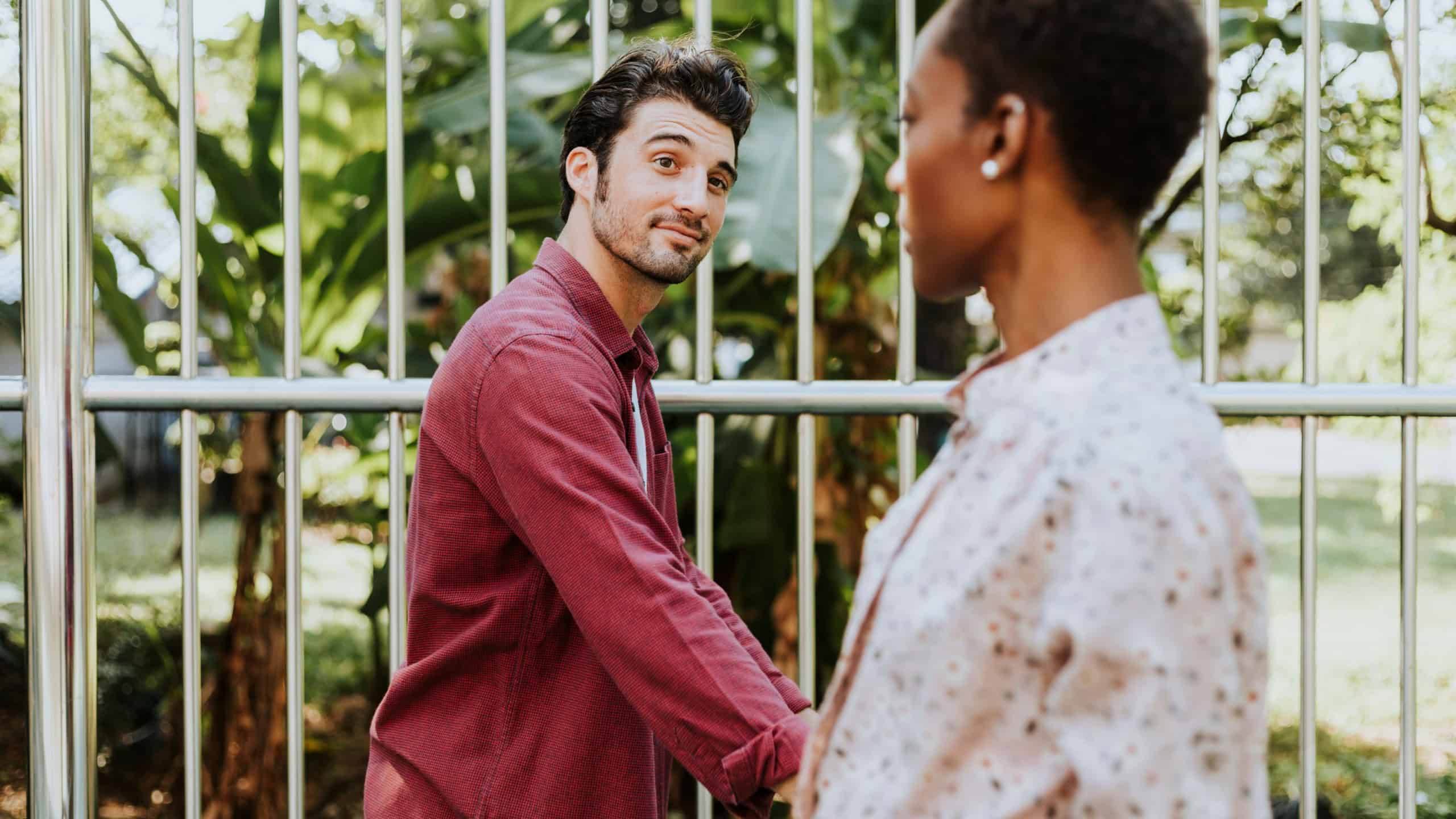 Man looking at a black lady while walking past her