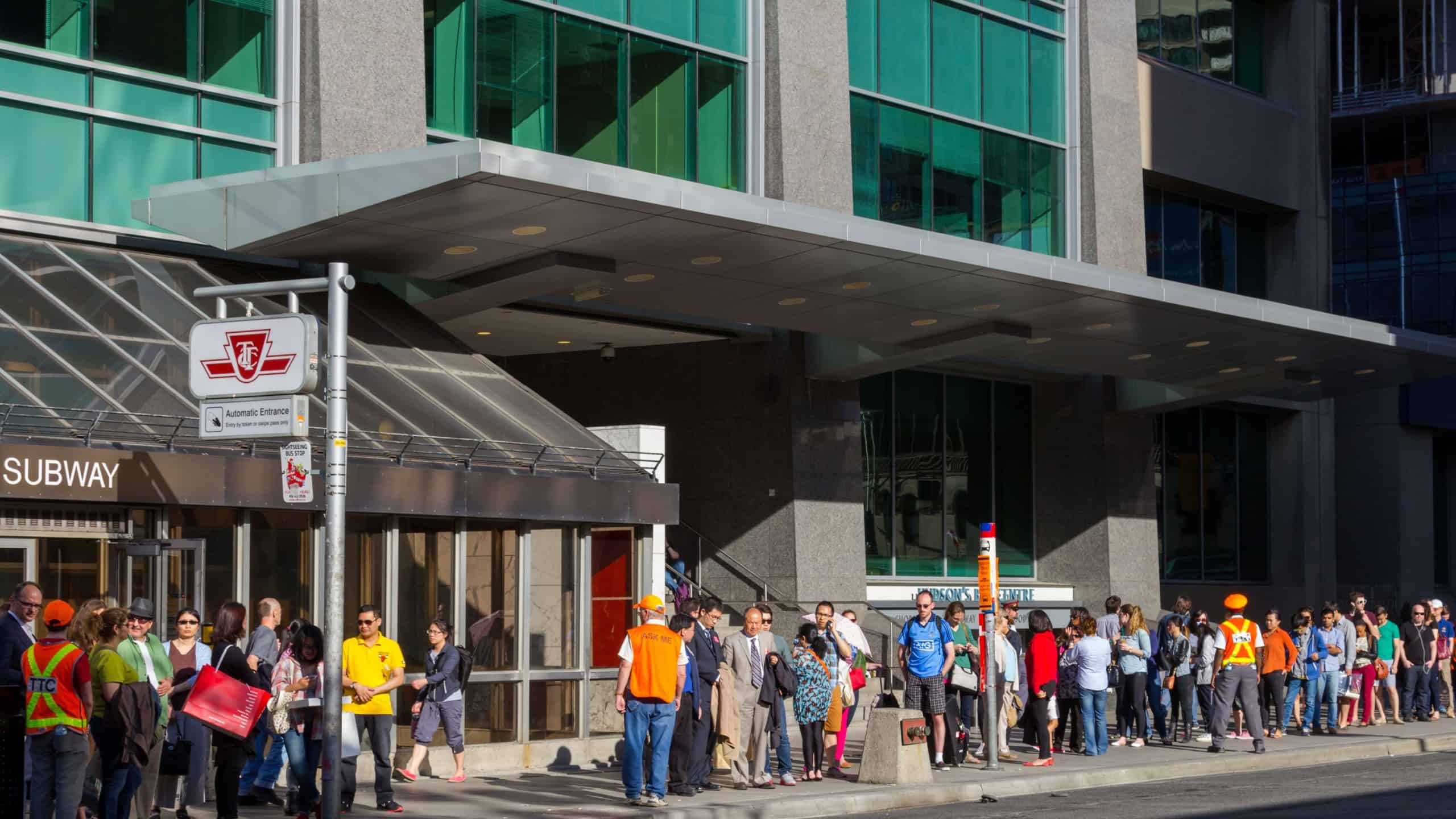 TORONTO, CANADA - MAY 31, 2014: Long queues of people outside Bloor Station in Toronto waiting for the shuttle bus's running whilst the subway is closed