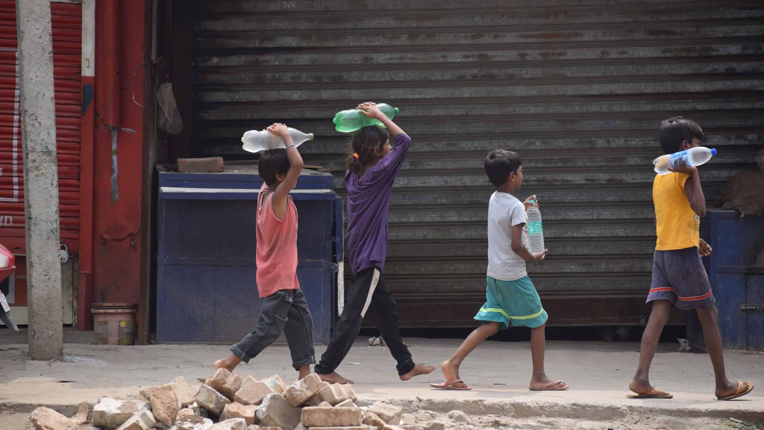 Due to non-availability of drinking water in Badshahpur area of Millennium City Gurgaon, children fetch water from far off places. Gurgaon, India. August 02, 2023.