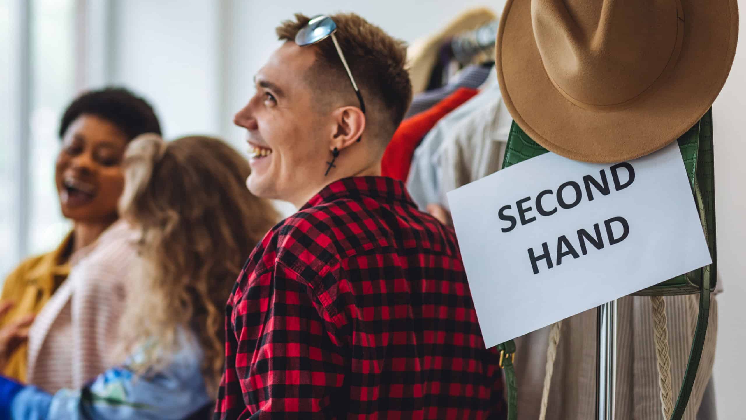 Young people, generation z shopping in a second hand store, vintage finds, branded clothes. Bargain hunting, pre-owned goods, thrift store. Sustainable lifestyle, eco friendly conscious consumerism
